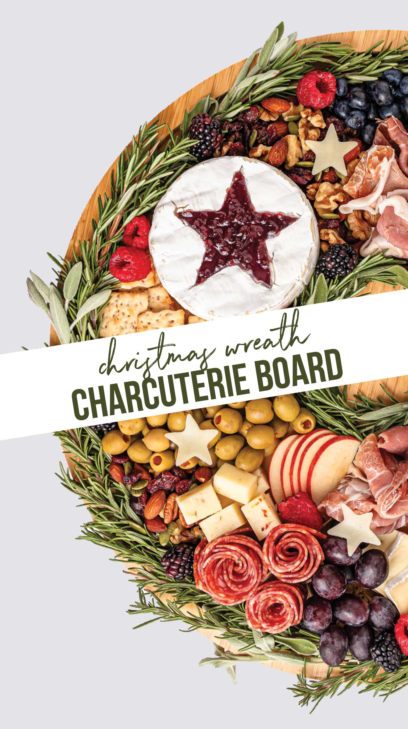 chrismtas charcuteried board with wording over the cheese, nuts, herbs, meats and crackers