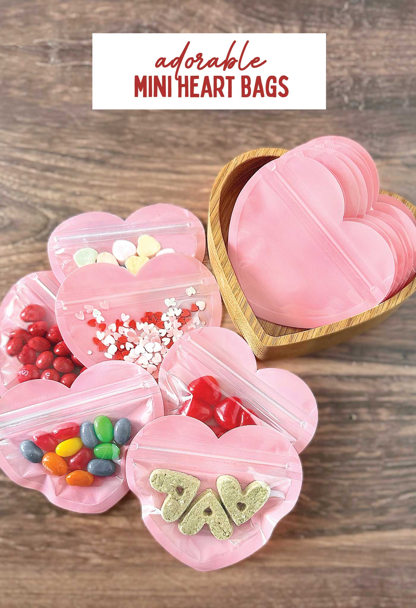 pink heart bag with candy, confetti and dog treats in them for valentine's day