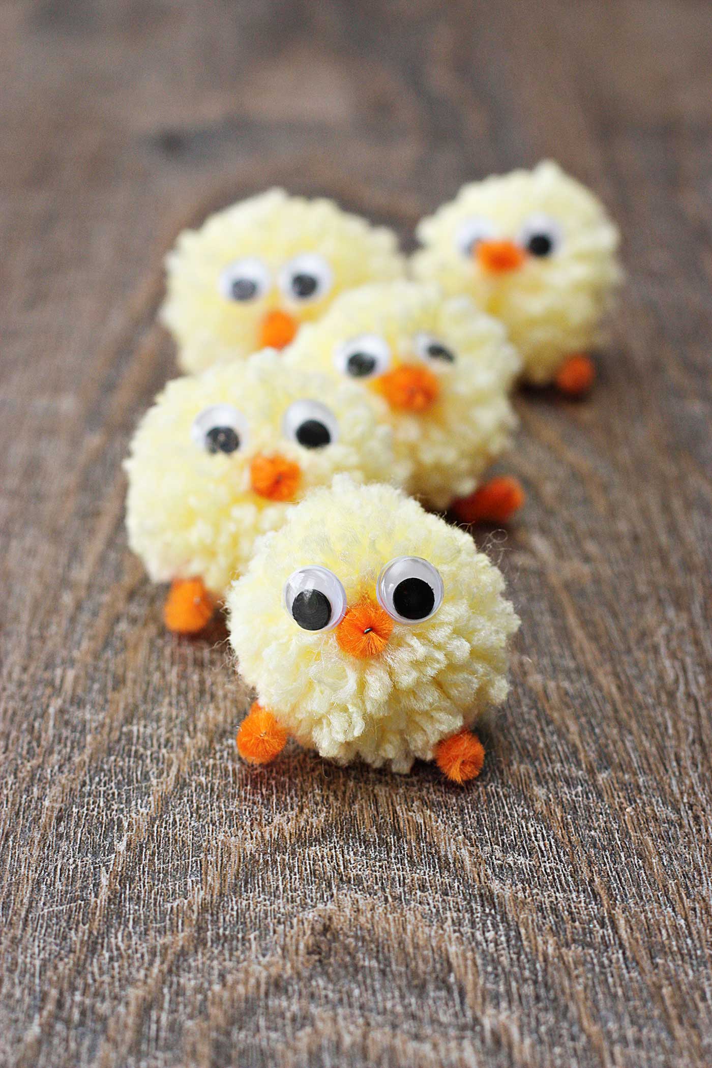 little yarn chicks made of pom poms, pipe cleaners and wiggly eyes