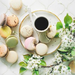 plate with coffee and macaroons with flowers