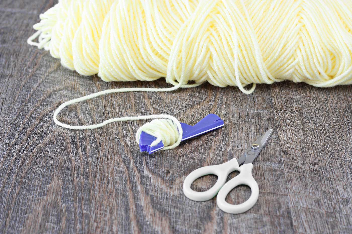 a pair of scissors and skein of yarn 