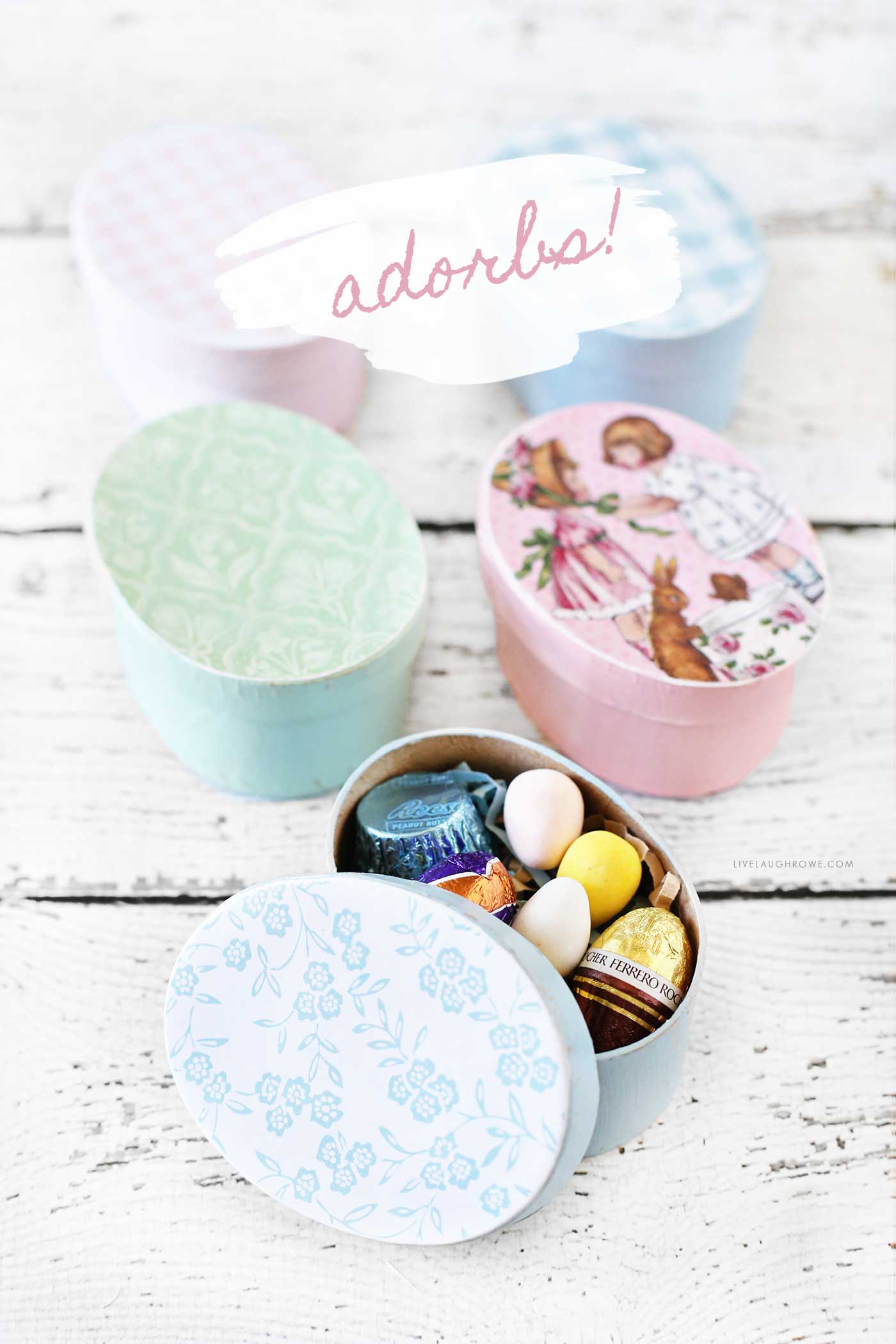 handmade easter treat boxes sitting on a white wooden background.