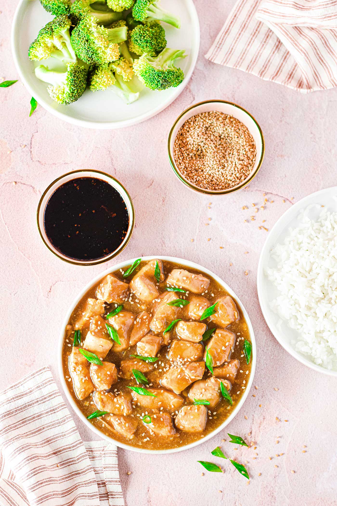 multiple prep bowls filled with ingredients and a bowl of teriyaki chicken