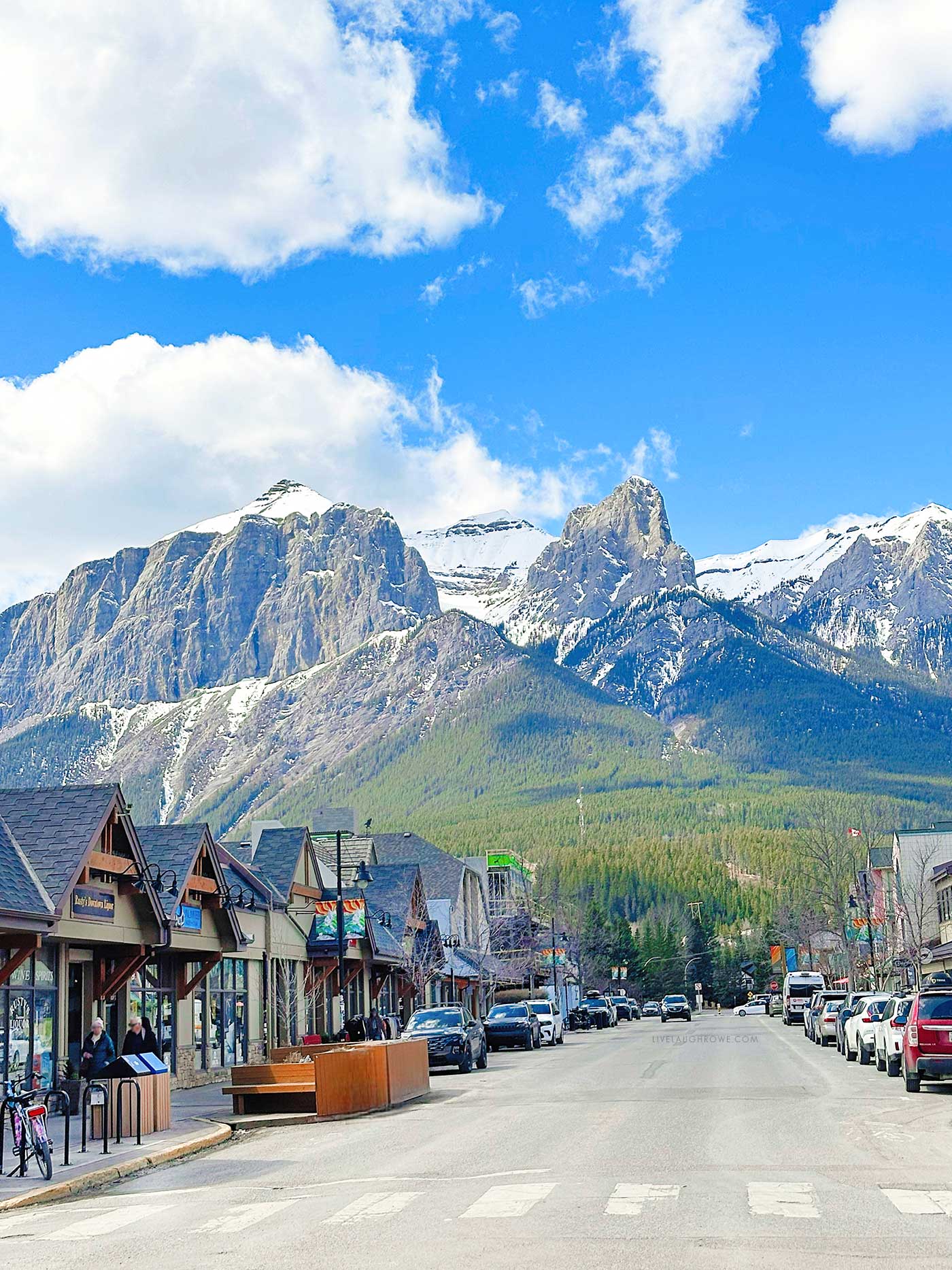 mountain town. canmore, alberta with massive mountains and blue skies as the backdrop 
