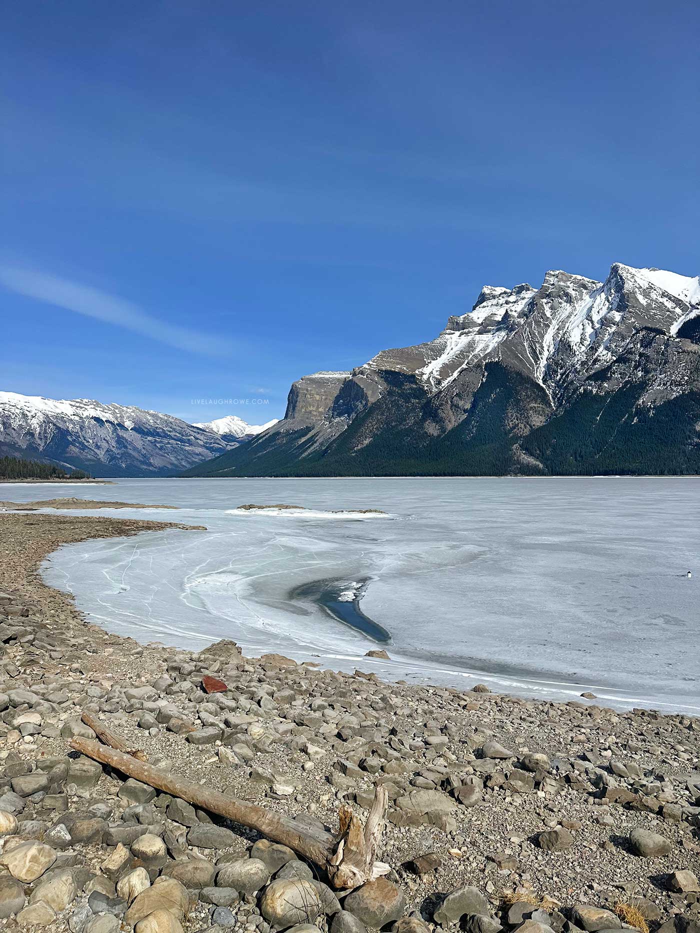 pebble beach, frozen lake and canadian rocky mountains