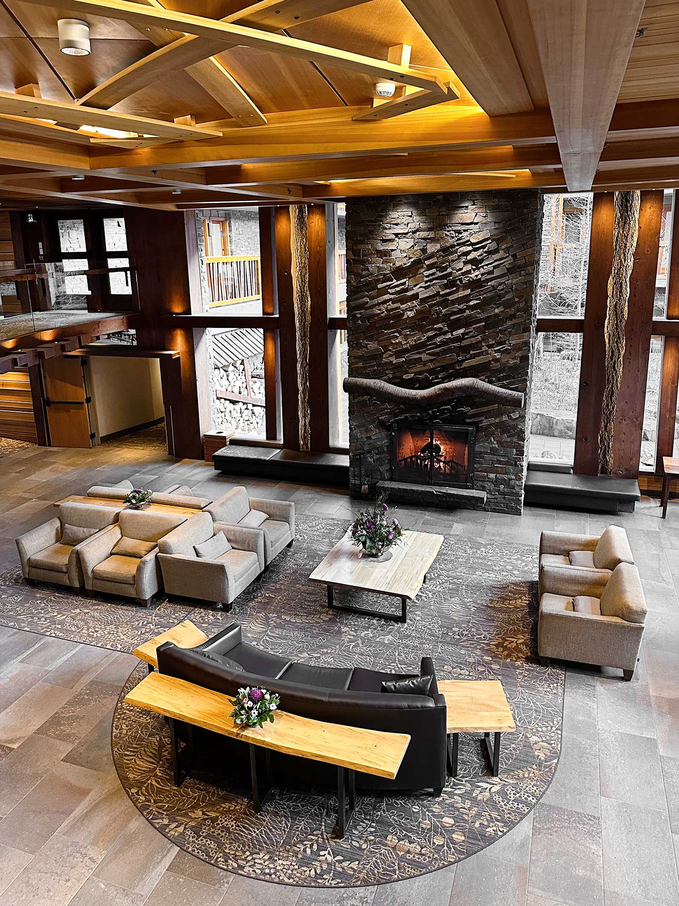 rustic lobby with large stone fireplace at Moose Lodge