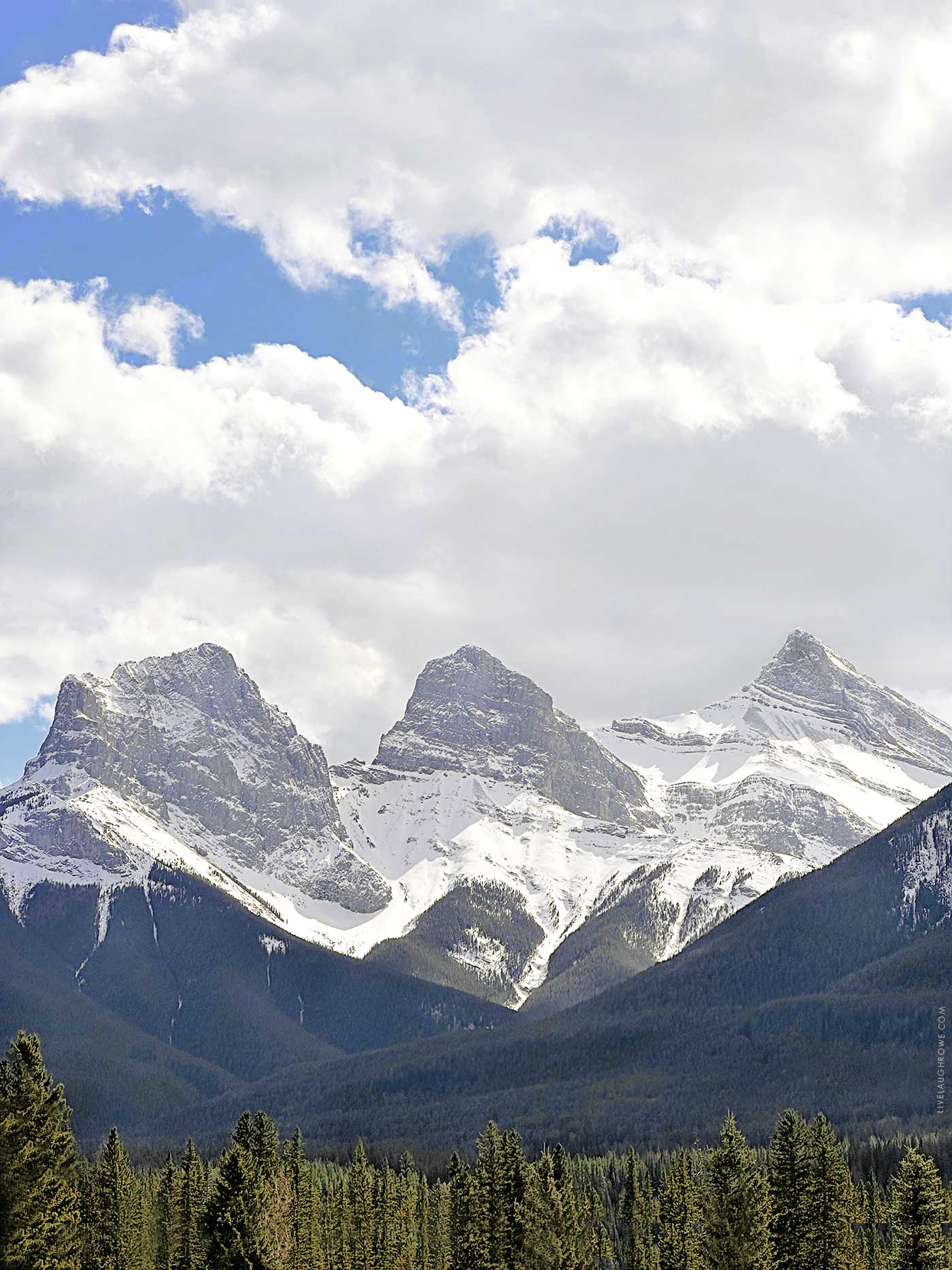 three mountain peaks known as three sisters in canmore, alberta.