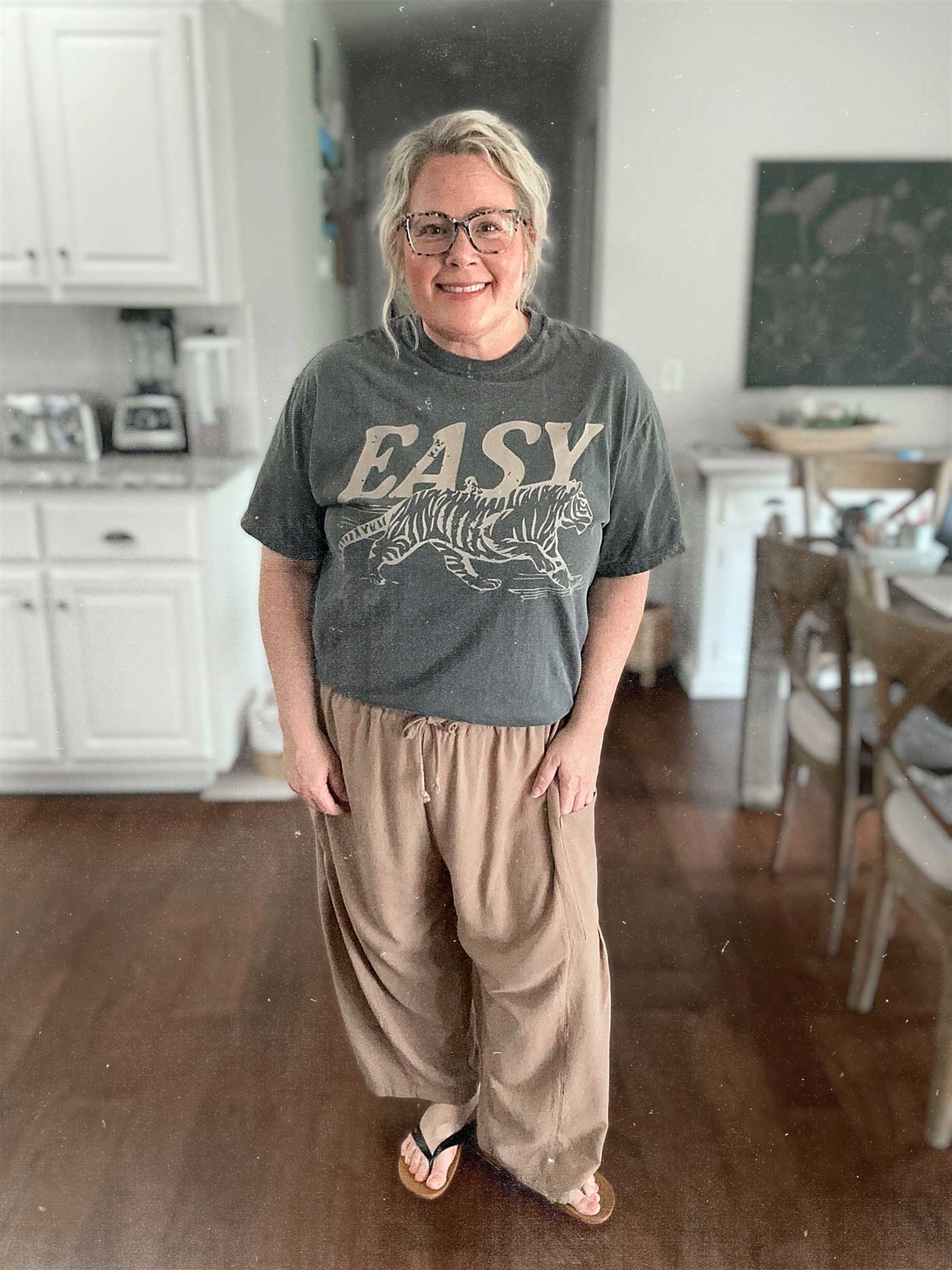 middle aged woman wearing an Easy Tiger t-shirt and linen pants