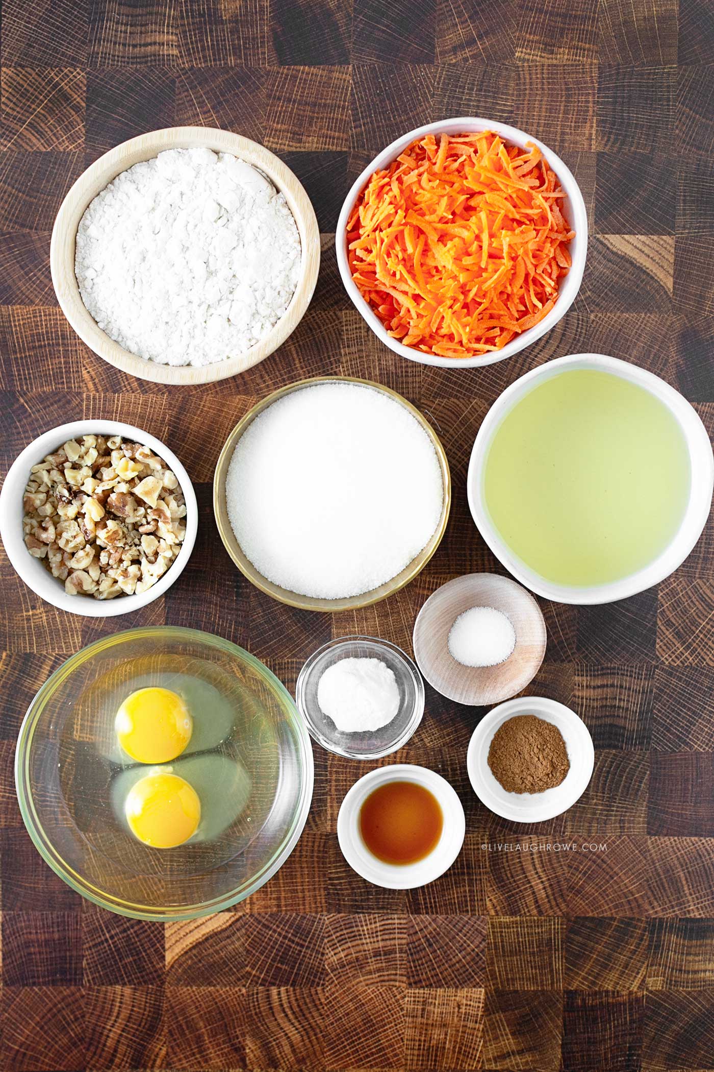 prep bowls full of ingredients such as carrots, oil, eggs, walnuts, and more.