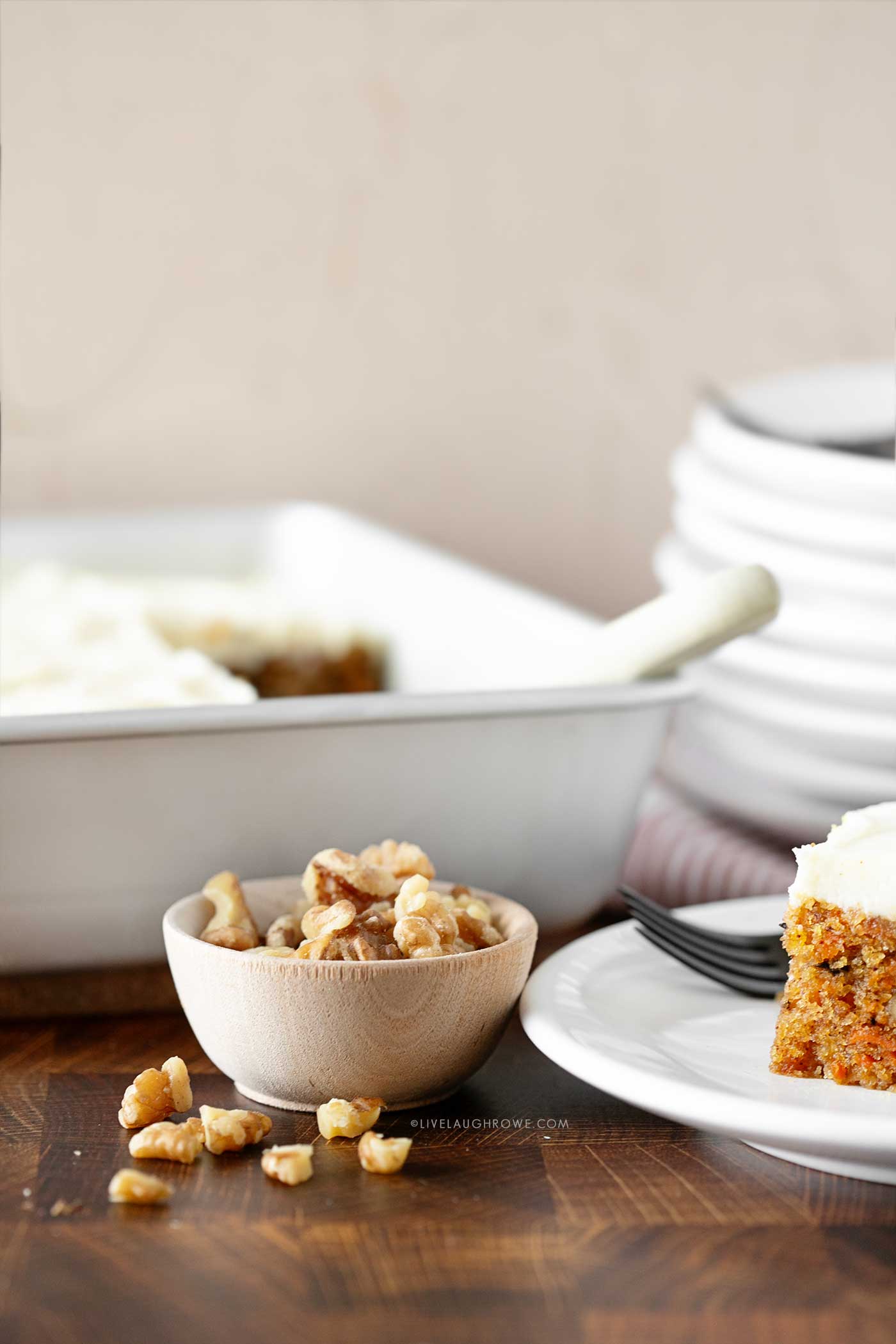 small prep bowl with walnuts, an ingredient for the carrot cake pictured