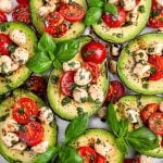 plated caprese stuffed avocados with basil for garnish