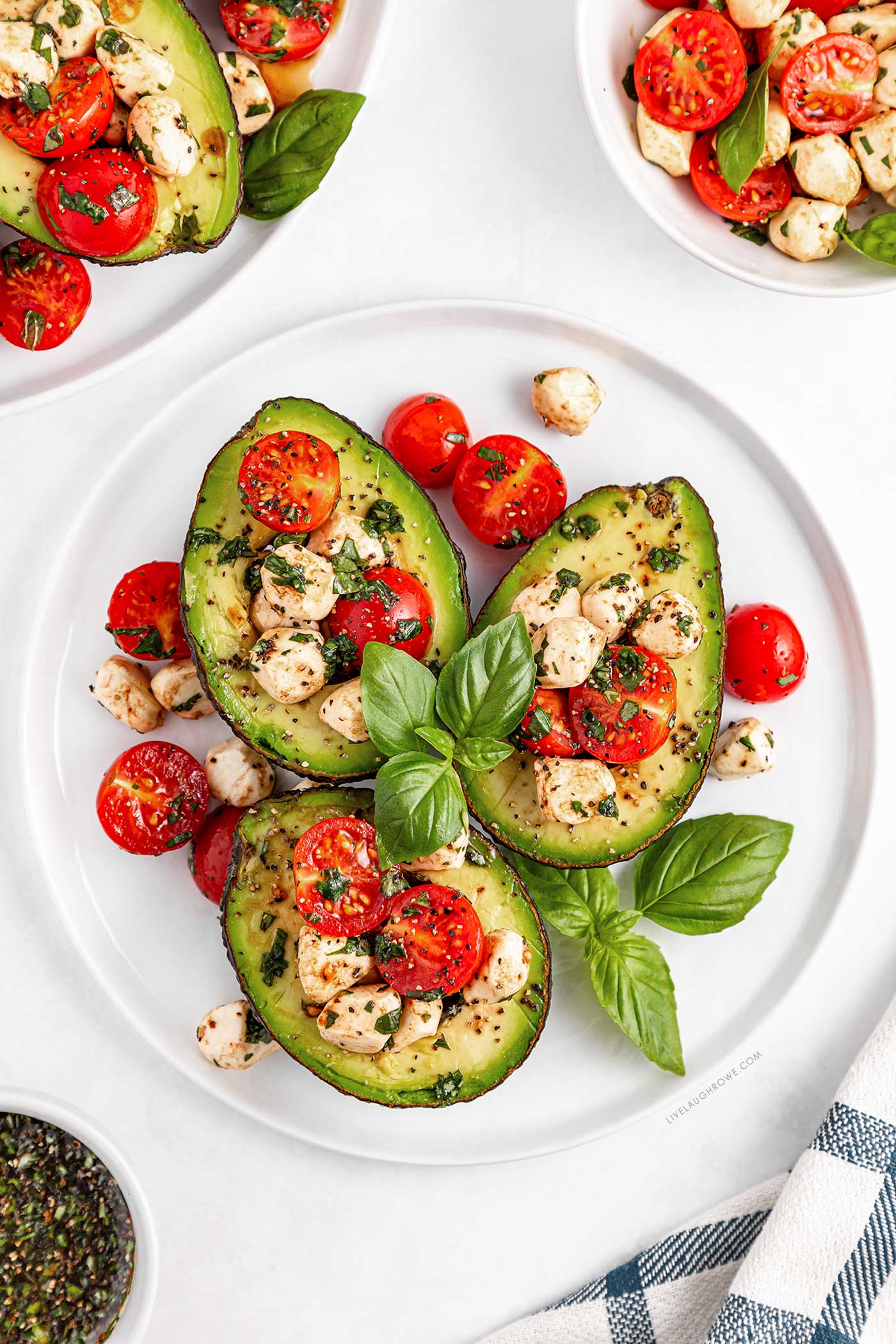 dinner plate with three. caprese stuffed avocados