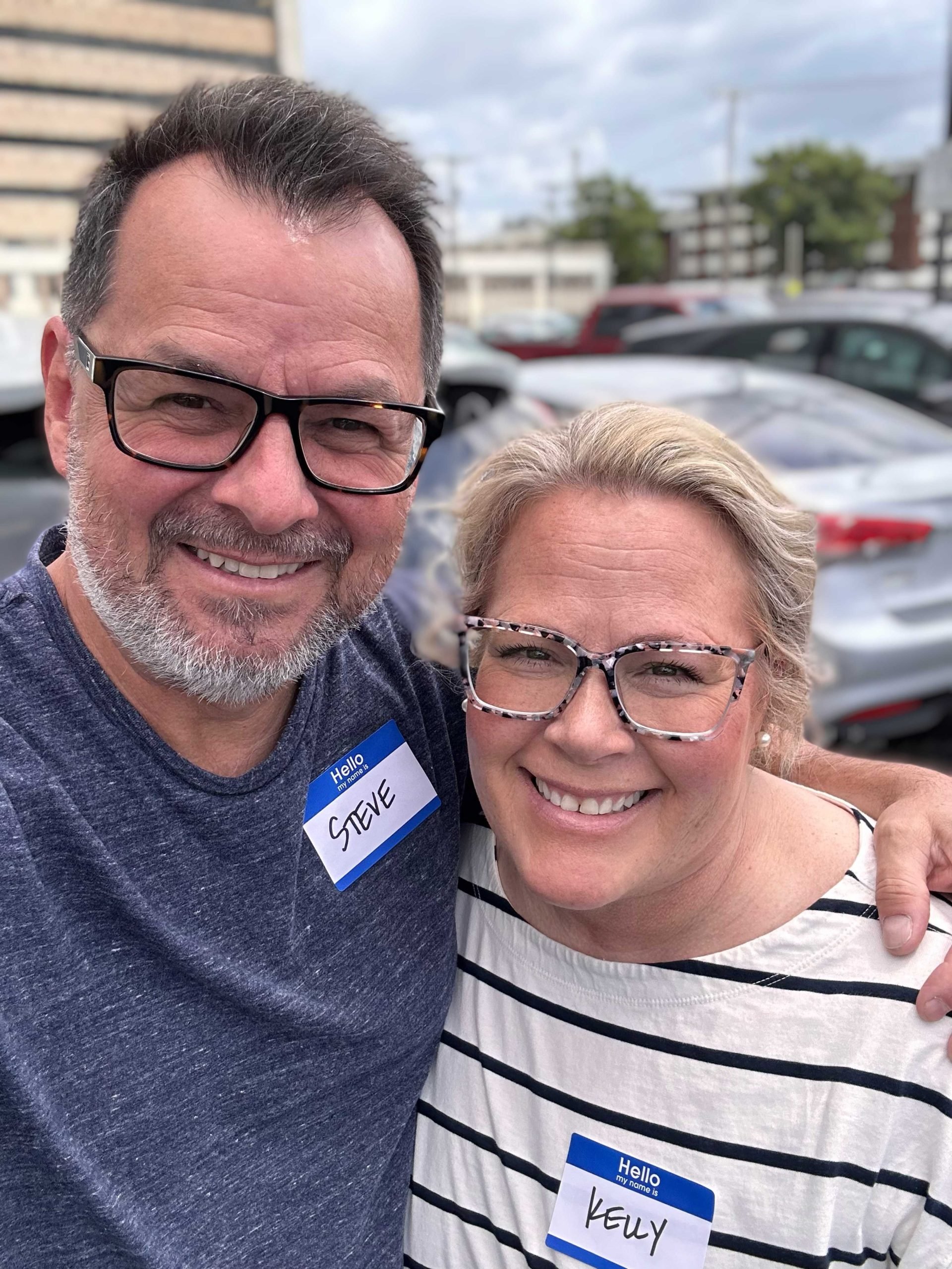 Smiling middle-aged couple wearing name tags