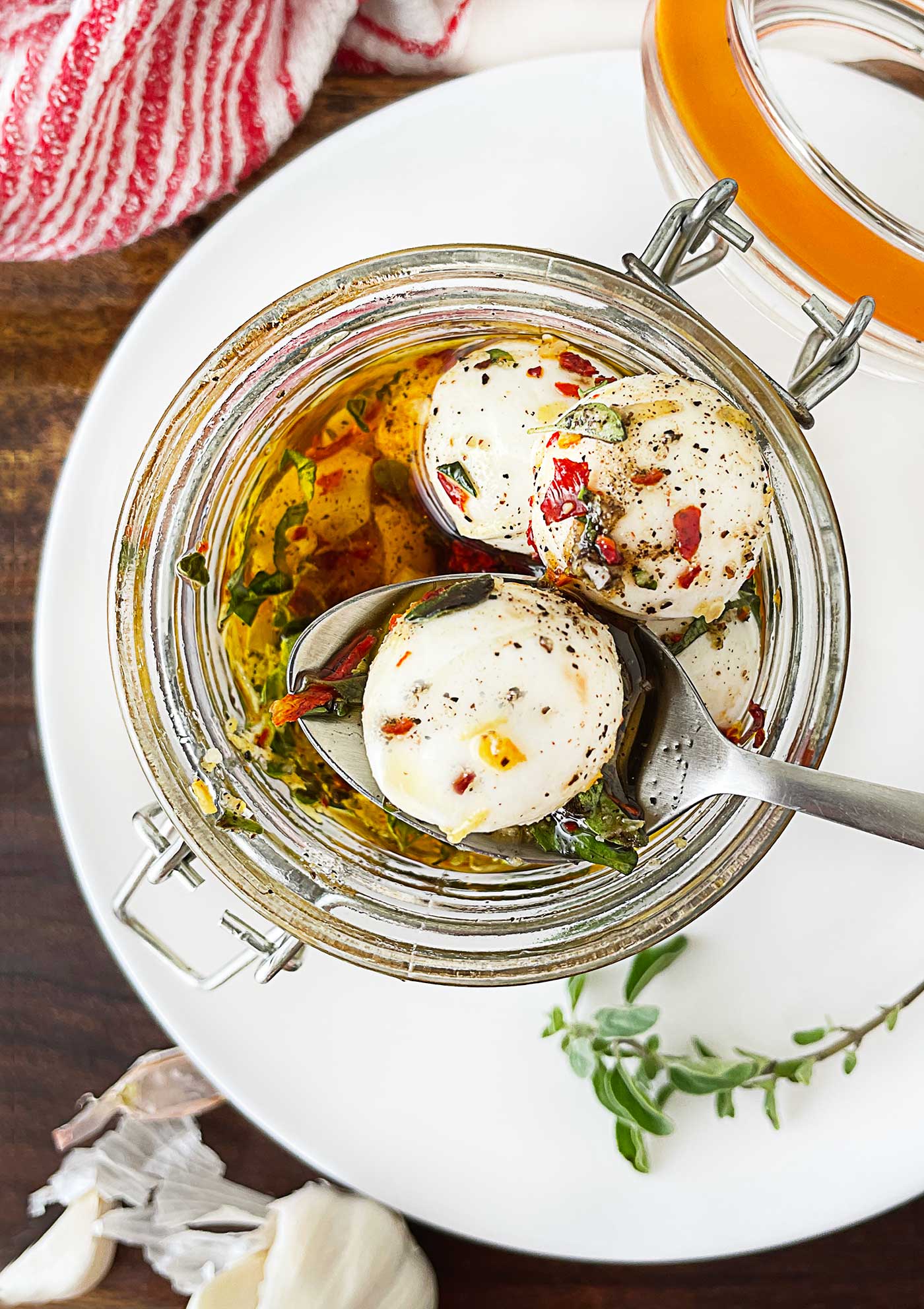 Ciliegine mozzarella balls marinated in olive oil, garlic, lemon zest, and fresh herbs.