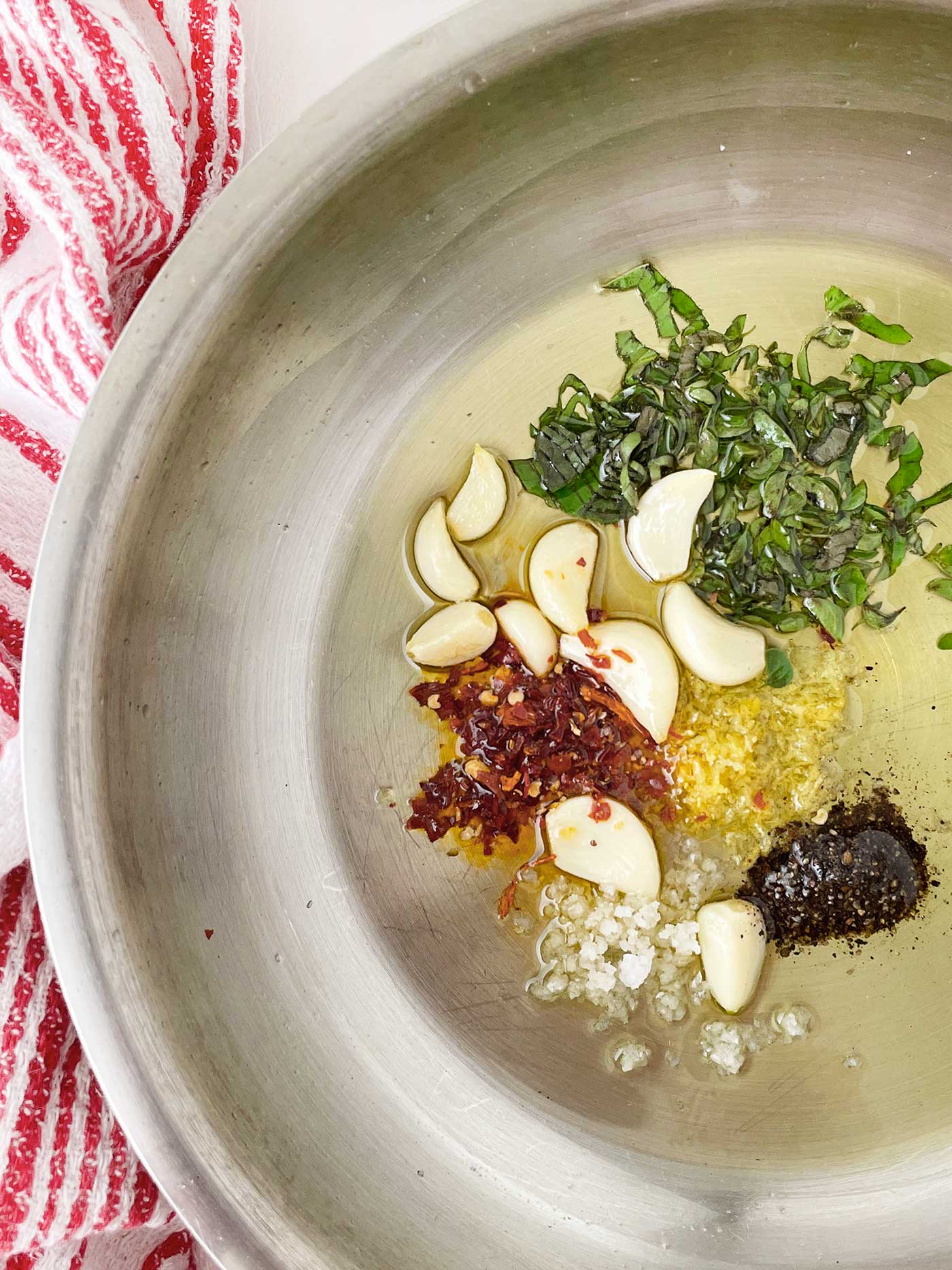oil and herbs in a frying pan to make a marinade