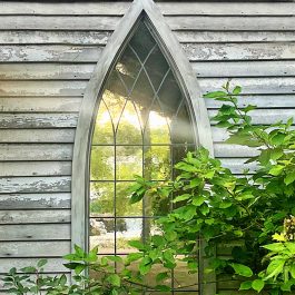 Finley River Chapel Window with greenery. In the background is the Finley River.
