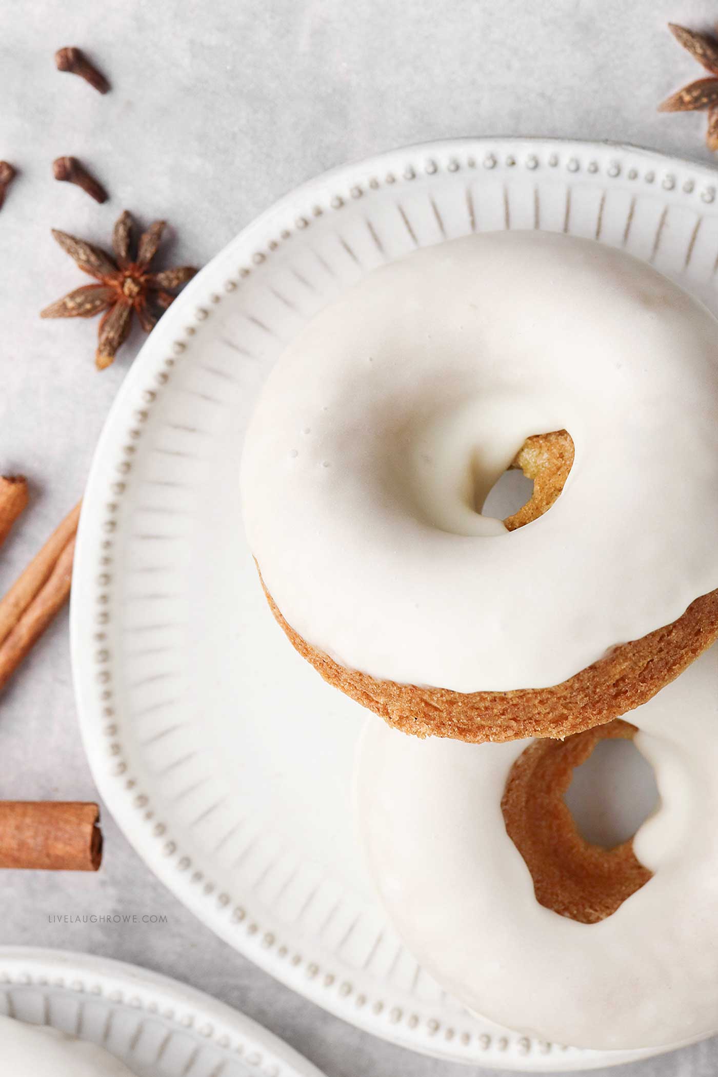 Close-up of glazed Orange Spice Donuts with warm autumn spices and citrus zest.