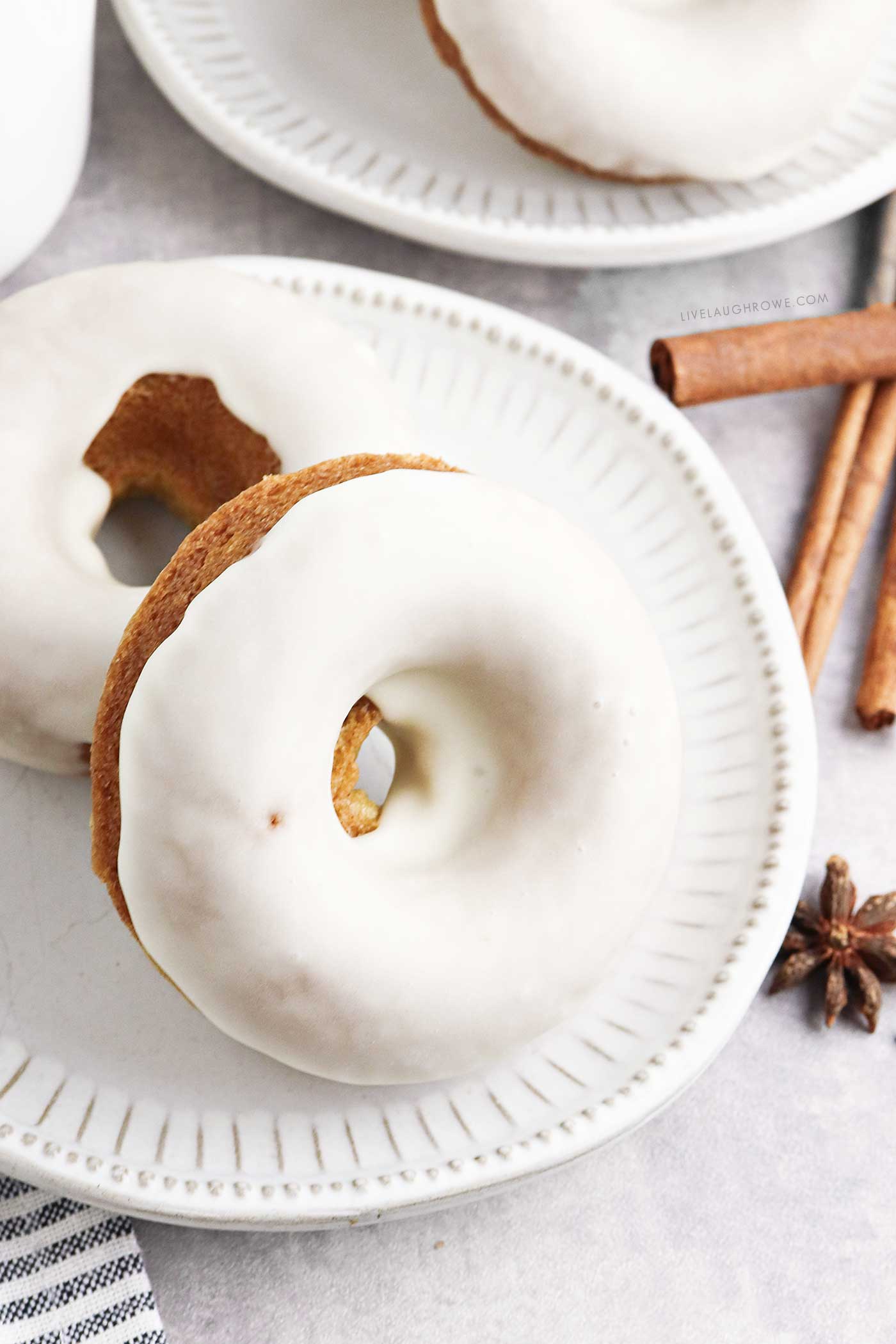 Baked, Glazed Donuts stacked on a plate, perfect for autumn mornings.