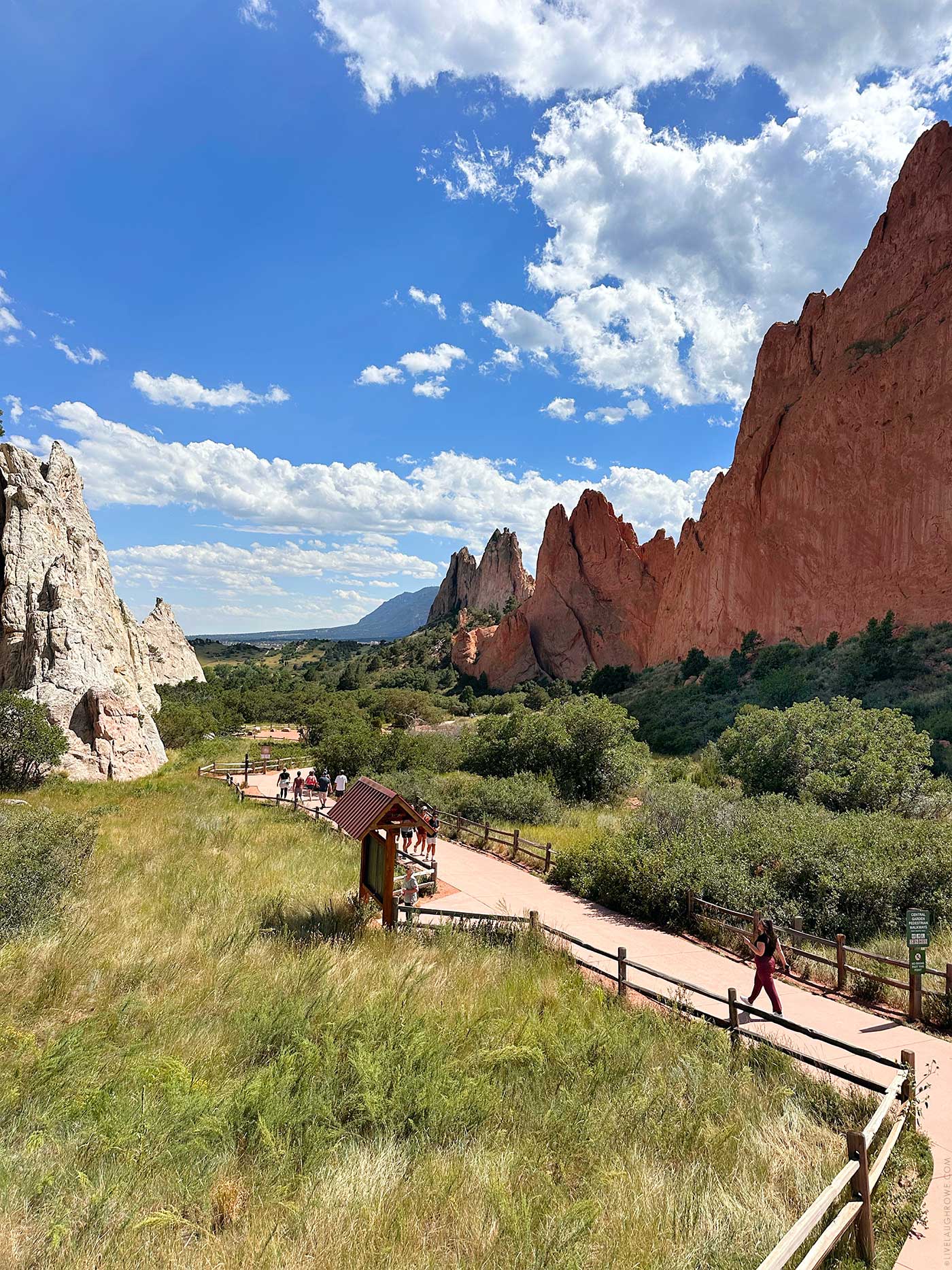 Garden of the Gods red rock formations with mountains in the background.