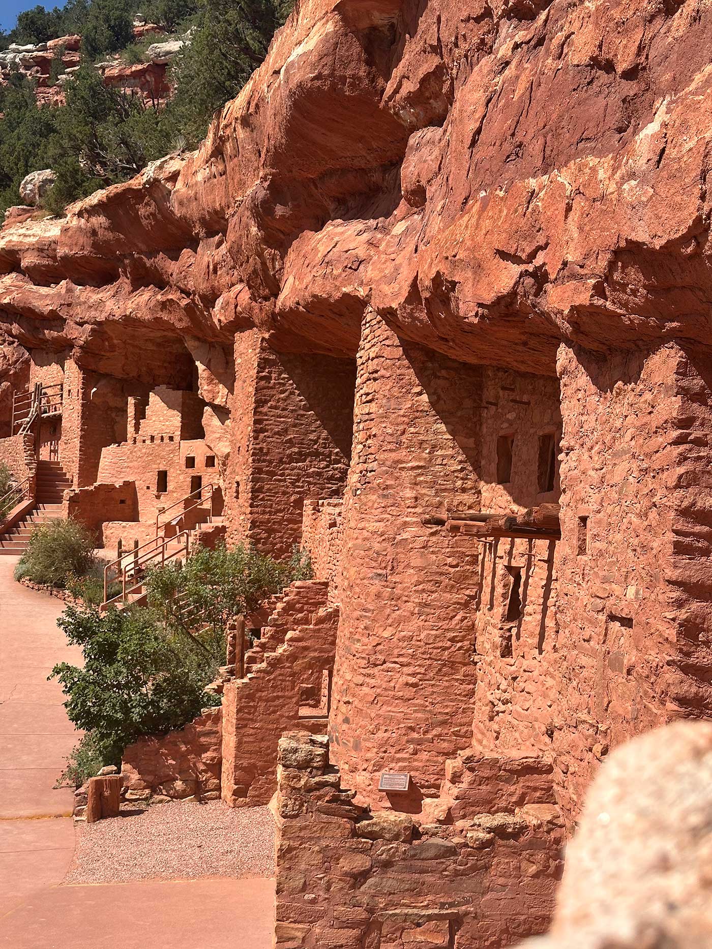 Ancient Manitou Cliff Dwellings built into red sandstone walls.