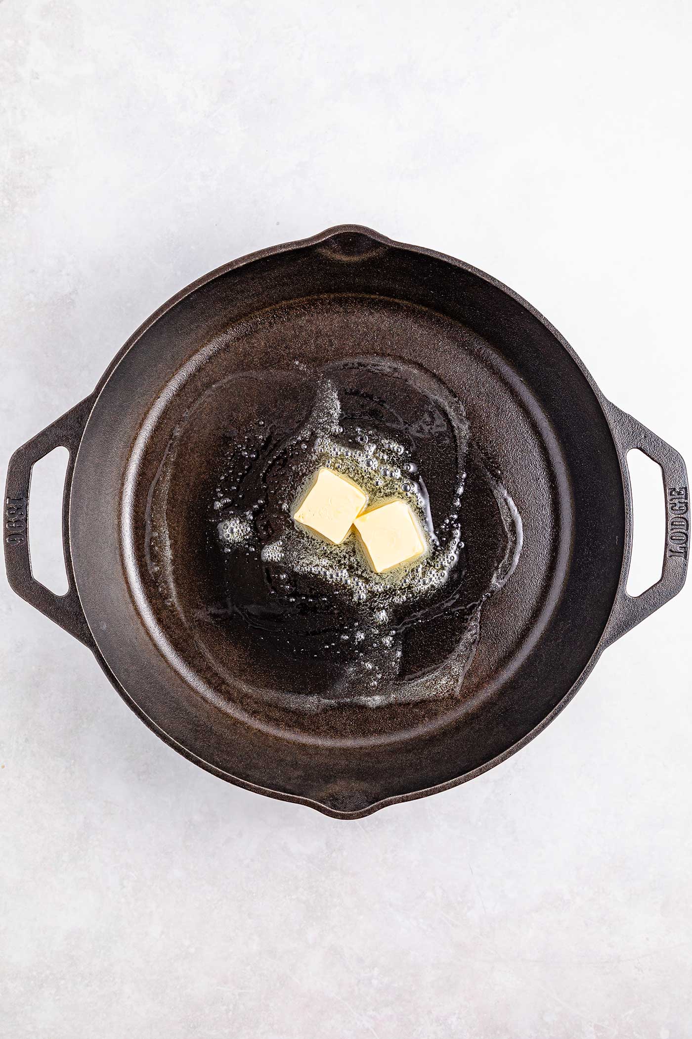 butter melting in a cast iron pan