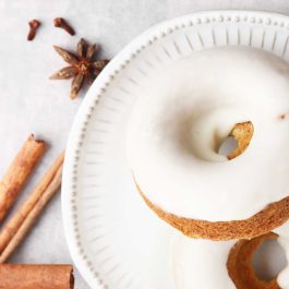 Close-up of glazed Orange Spice Donuts with warm autumn spices and citrus zest.