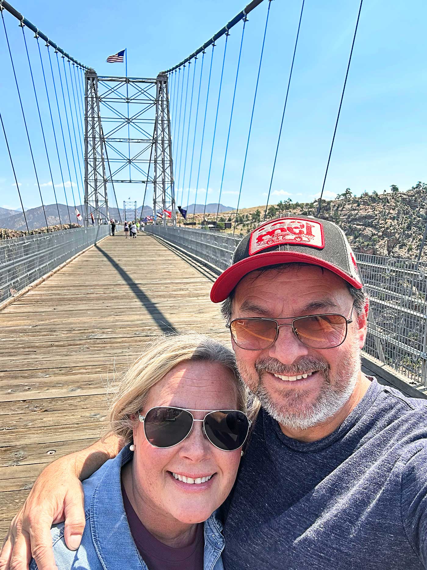 Couple smiling on suspension bridge over the Royal Gorge