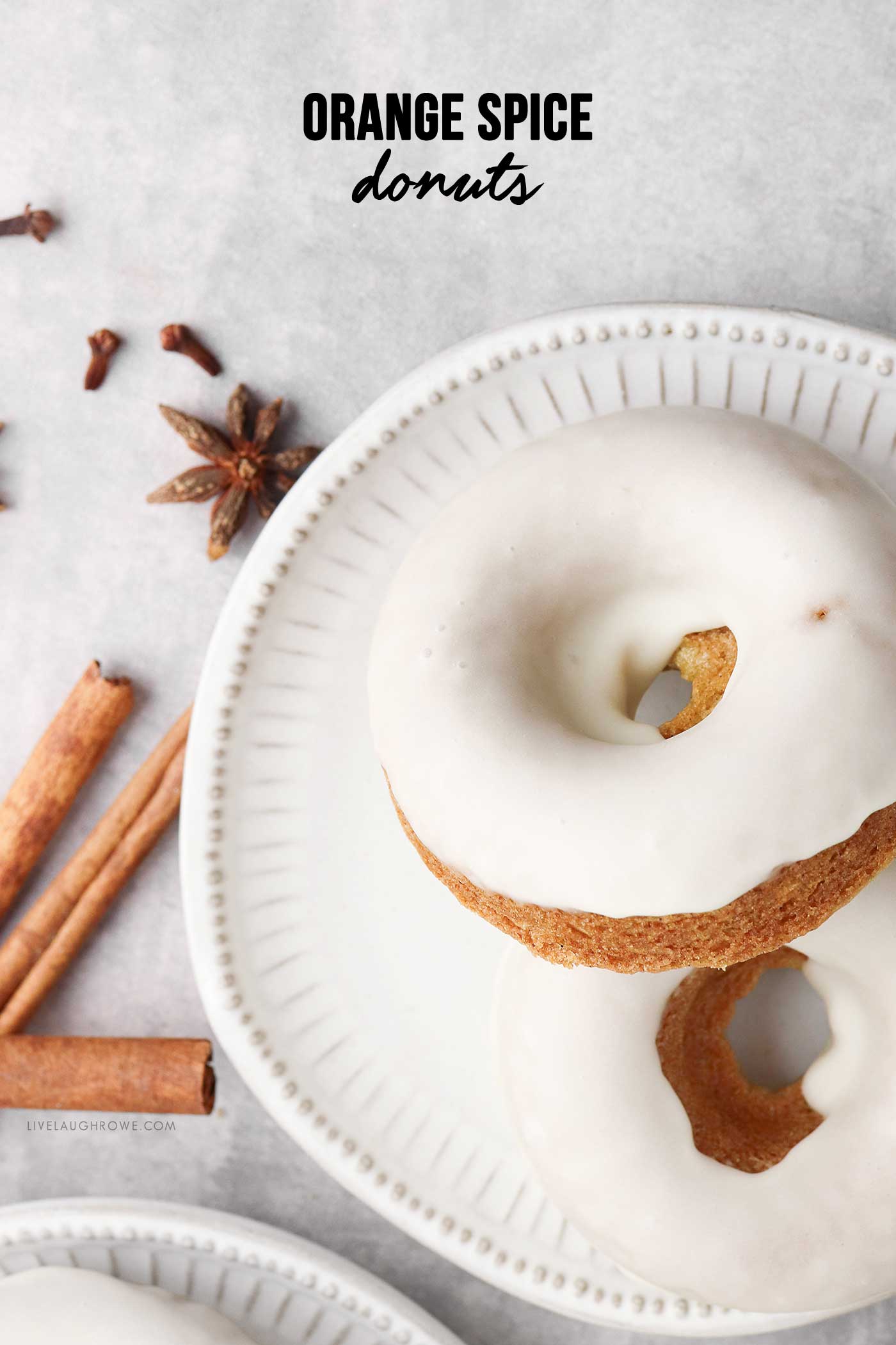Close-up of glazed Orange Spice Donuts with warm autumn spices and citrus zest.