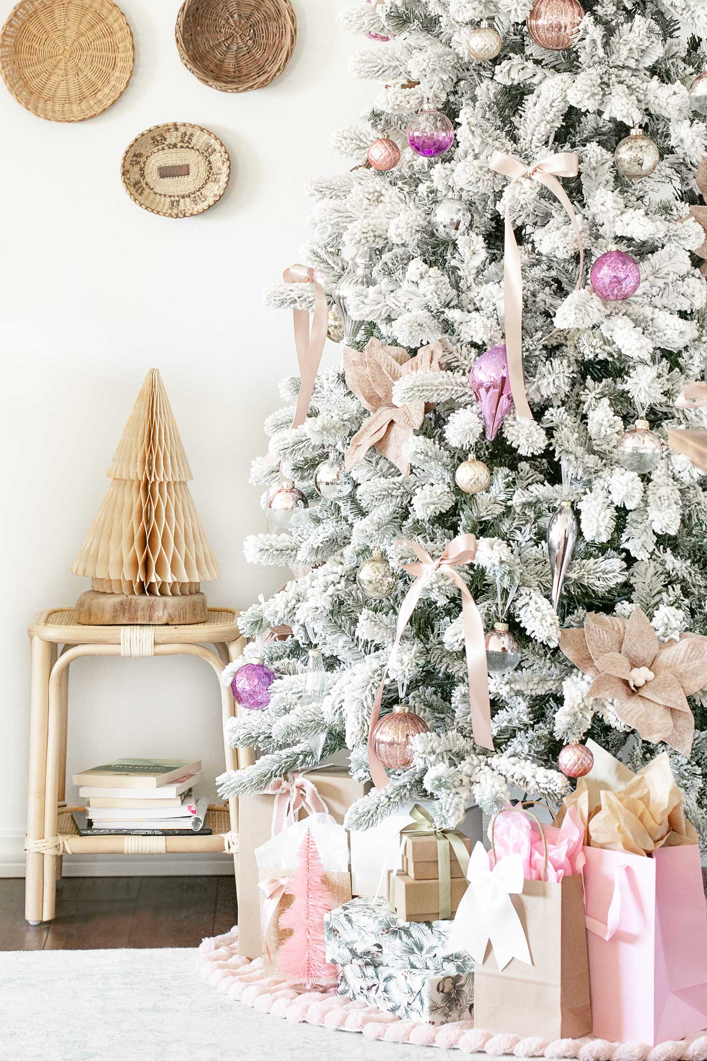 Elegant tree with satin bows, felt poinsettias, and sparkling glass ornaments. Paper tree sitting on bamboo stool beside the flocked tree.