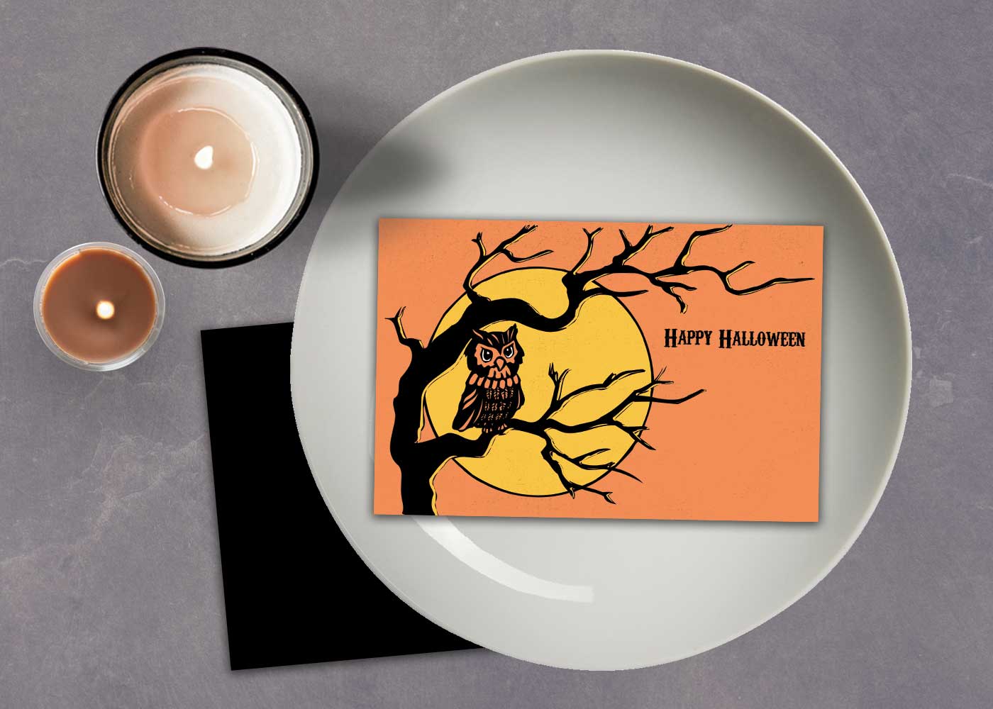 Printable used as a Halloween place card with candles and table setting — festive printable decor by Live Laugh Rowe.