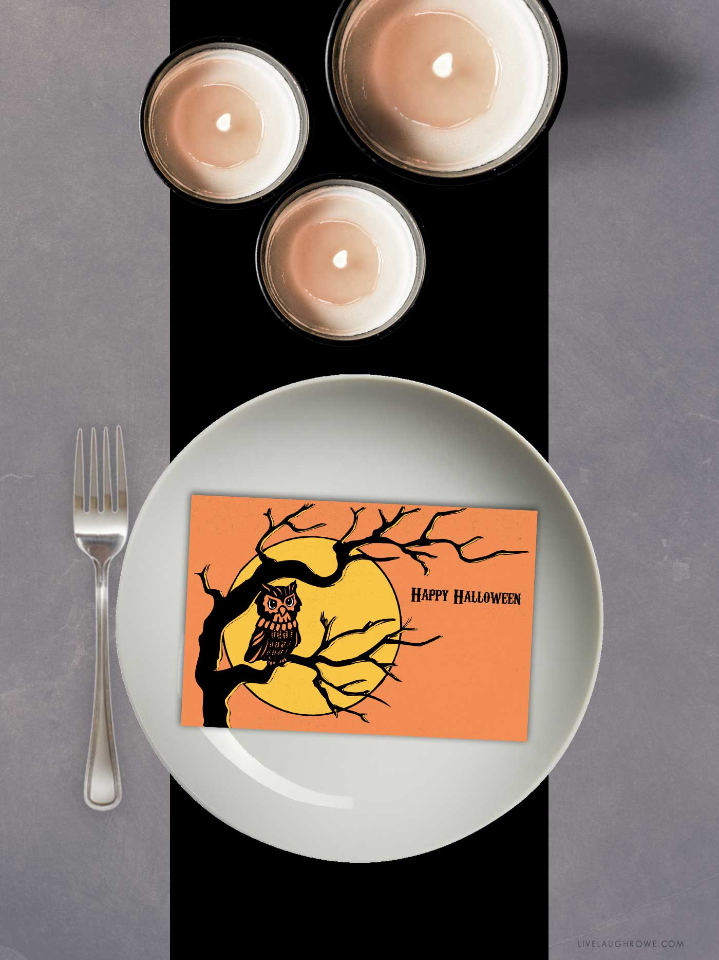 Postcard featuring an owl and moon, displayed as a Halloween place card on a white plate with black accents.