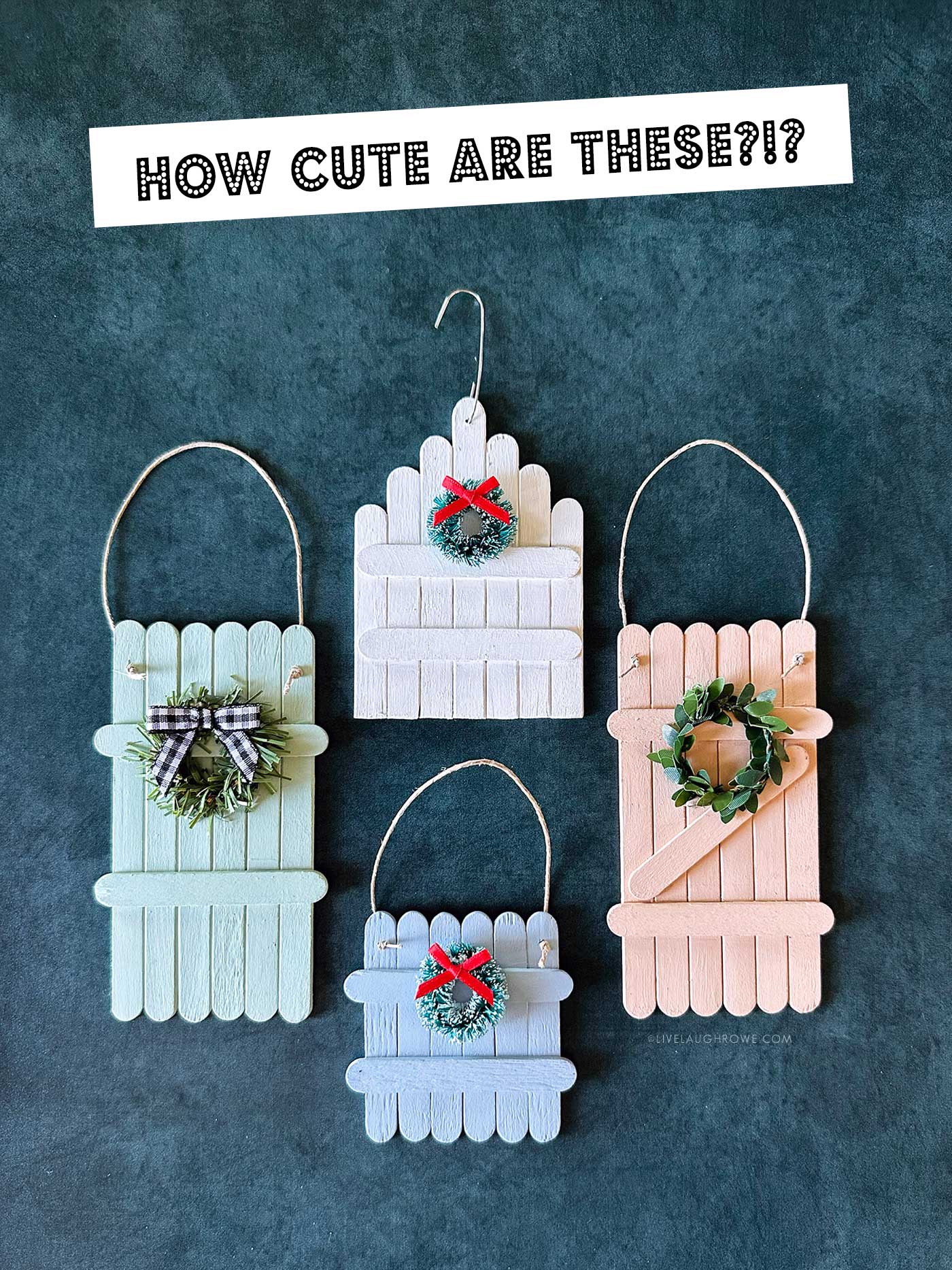 Four finished popsicle stick ornaments in pastel colors decorated with wreaths and bows.