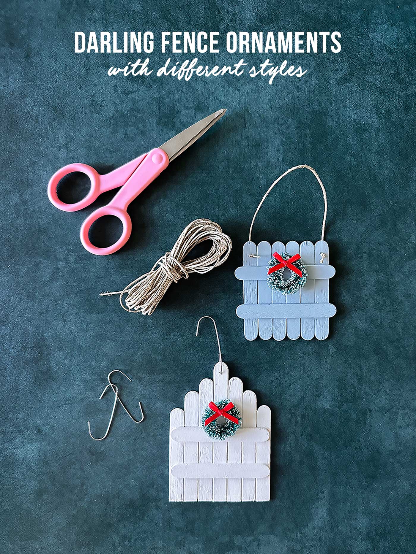 Pink scissors, twine, and hooks displayed with two ornaments made with popsickle sticks.
