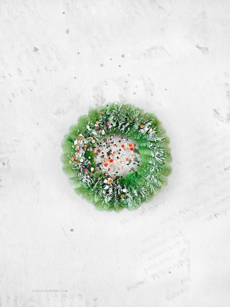 Decorating the mini pipe cleaner wreath with pearls and sequins.