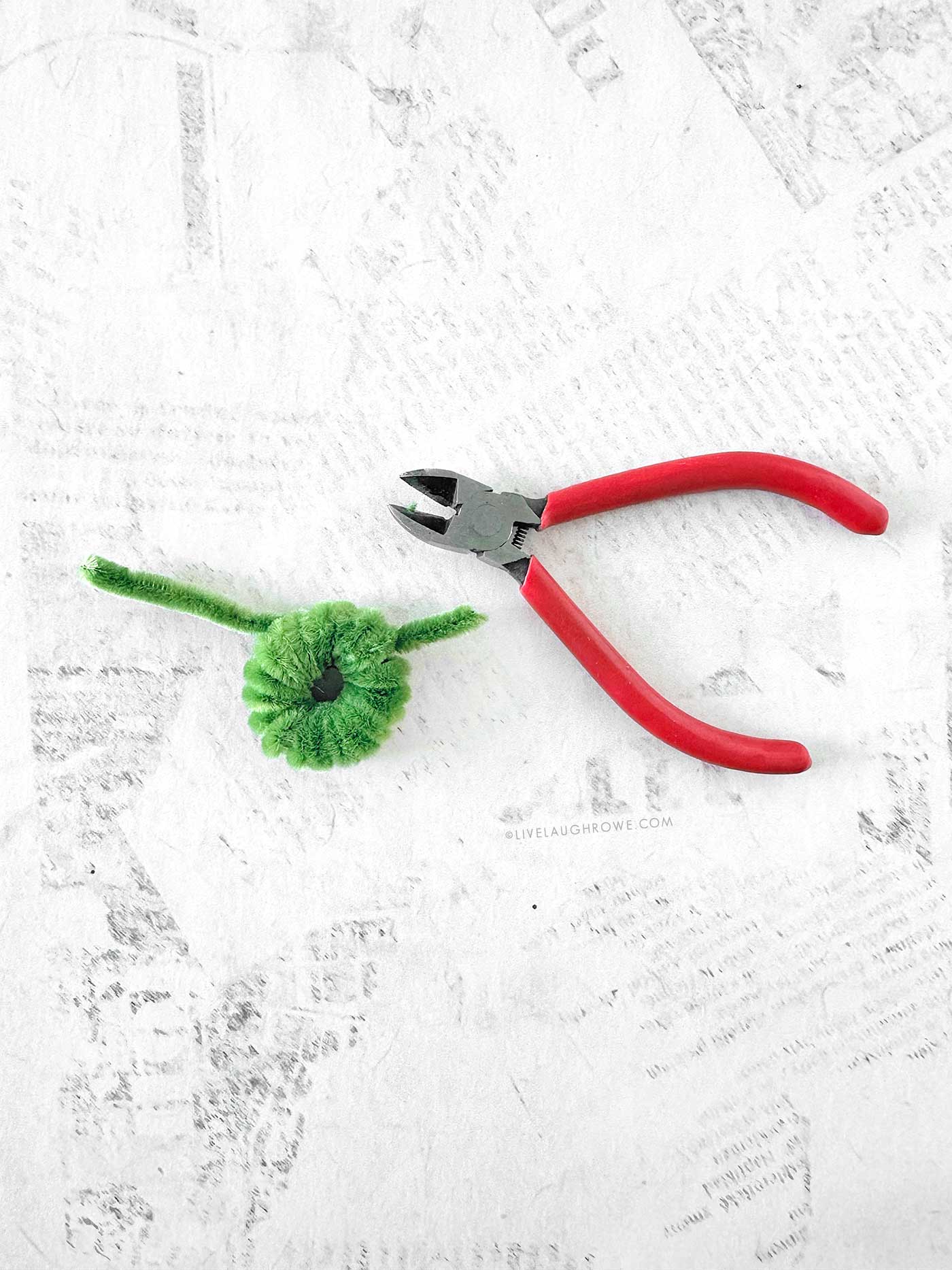 Tiny pipe cleaner wreath before embellishments, showing fluffy coils and secured ends.