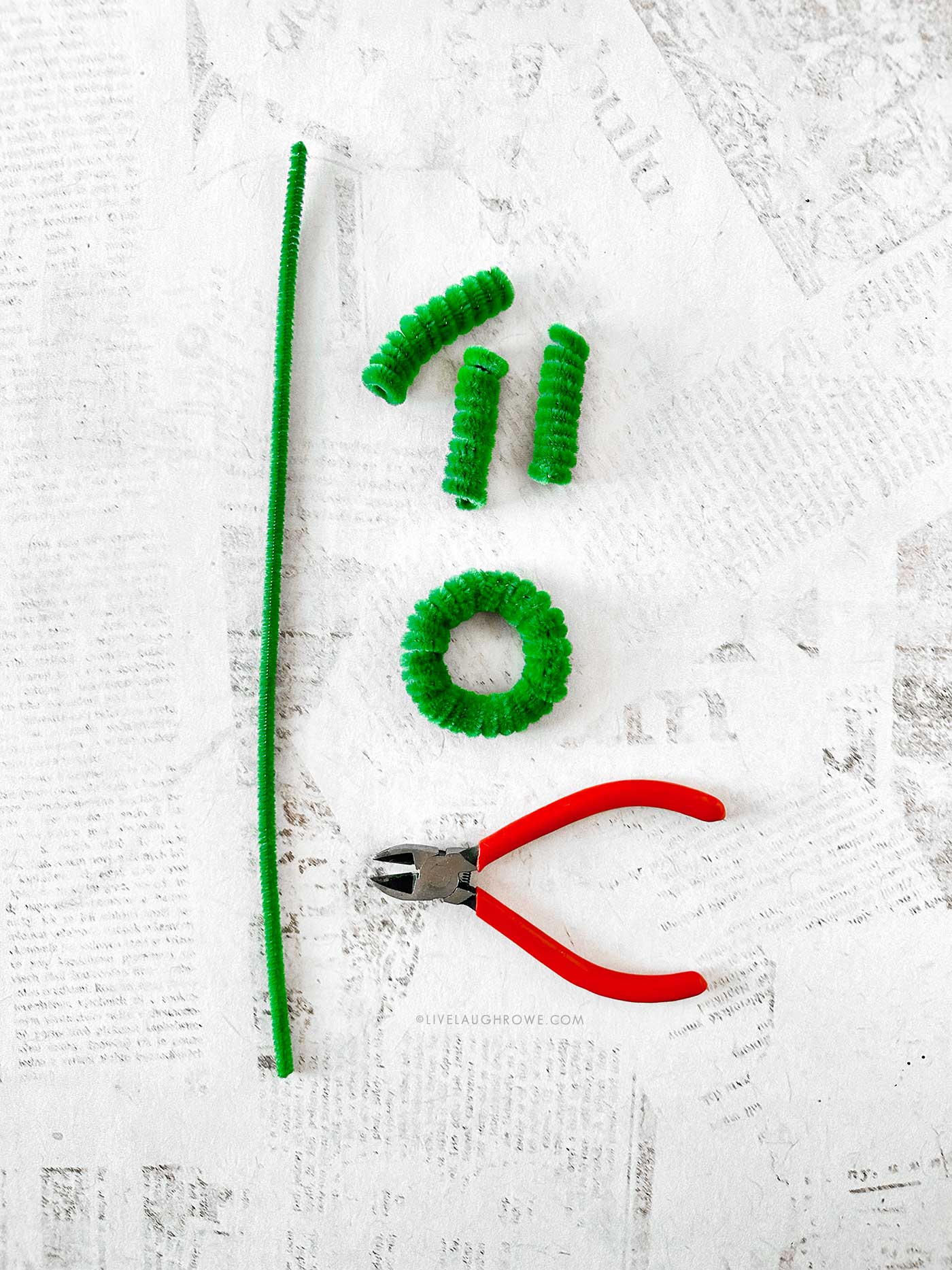 Tiny pipe cleaner wreath before embellishments, showing fluffy coils and secured ends.