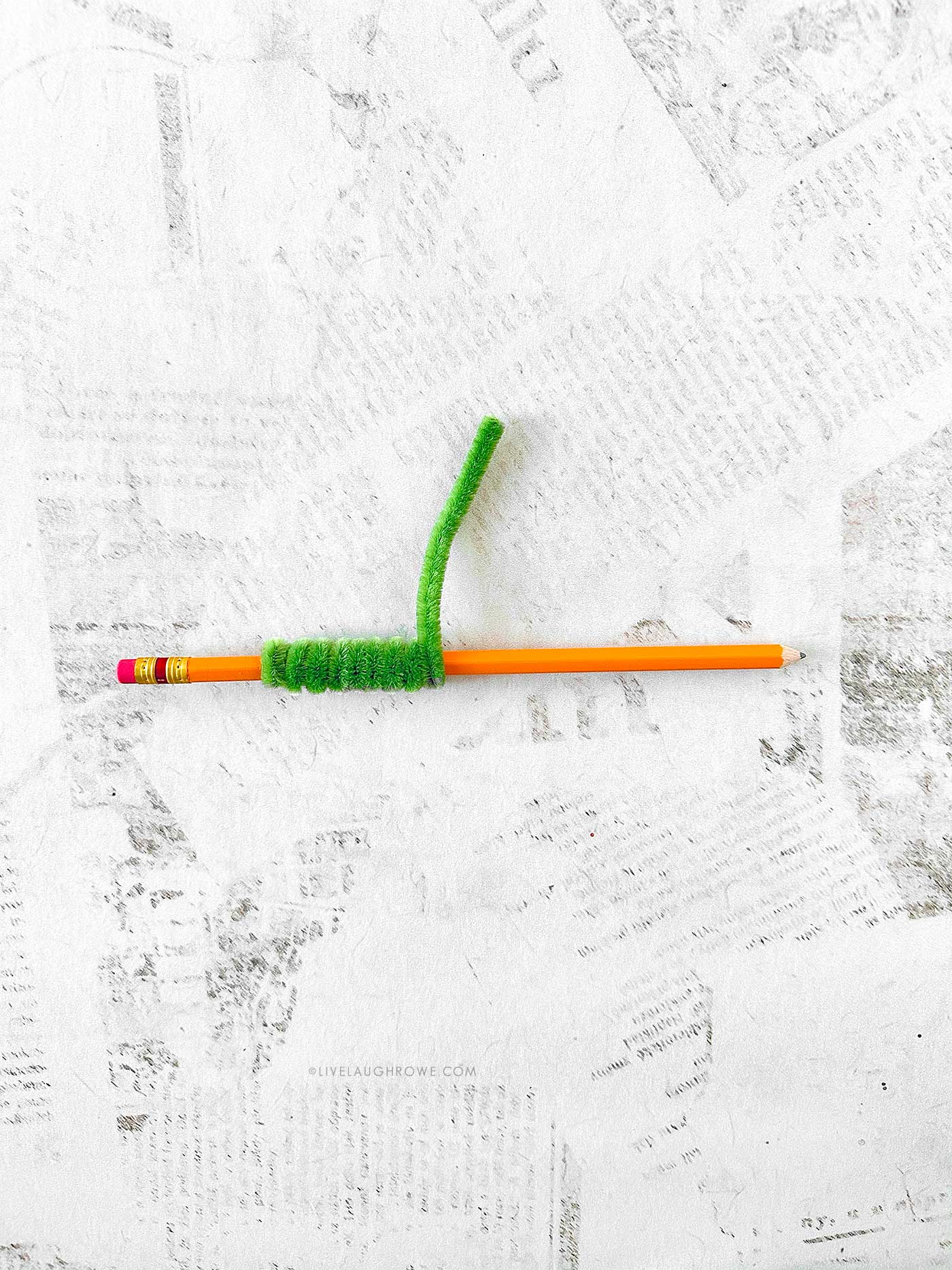 Pipe cleaners wrapped tightly around a pencil to create spiral coils for the wreath craft.
