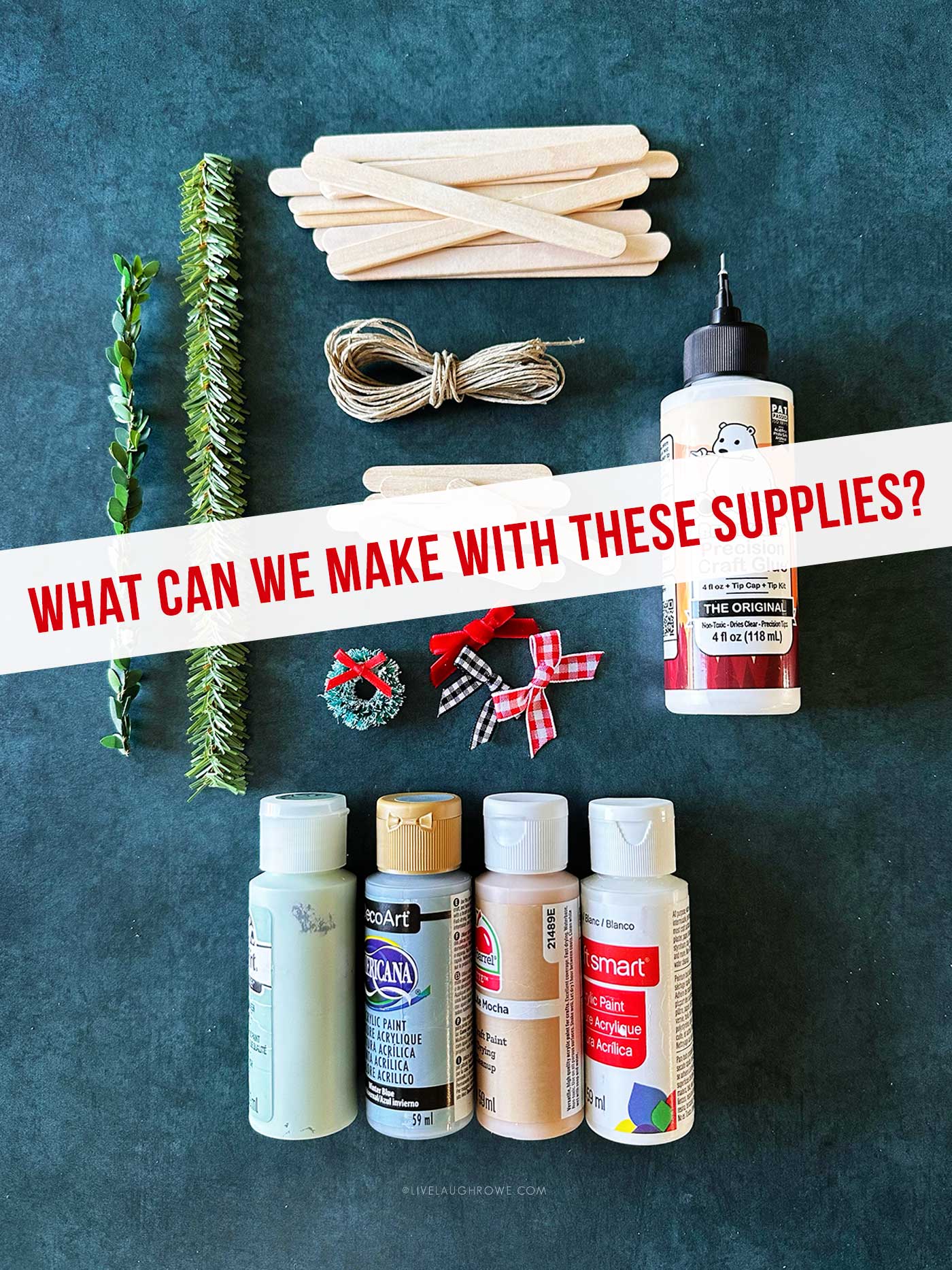 Craft supplies for making popsicle stick ornaments, including faux greenery, twine, popsicle sticks, mini wreaths, bows, paint, and craft glue.