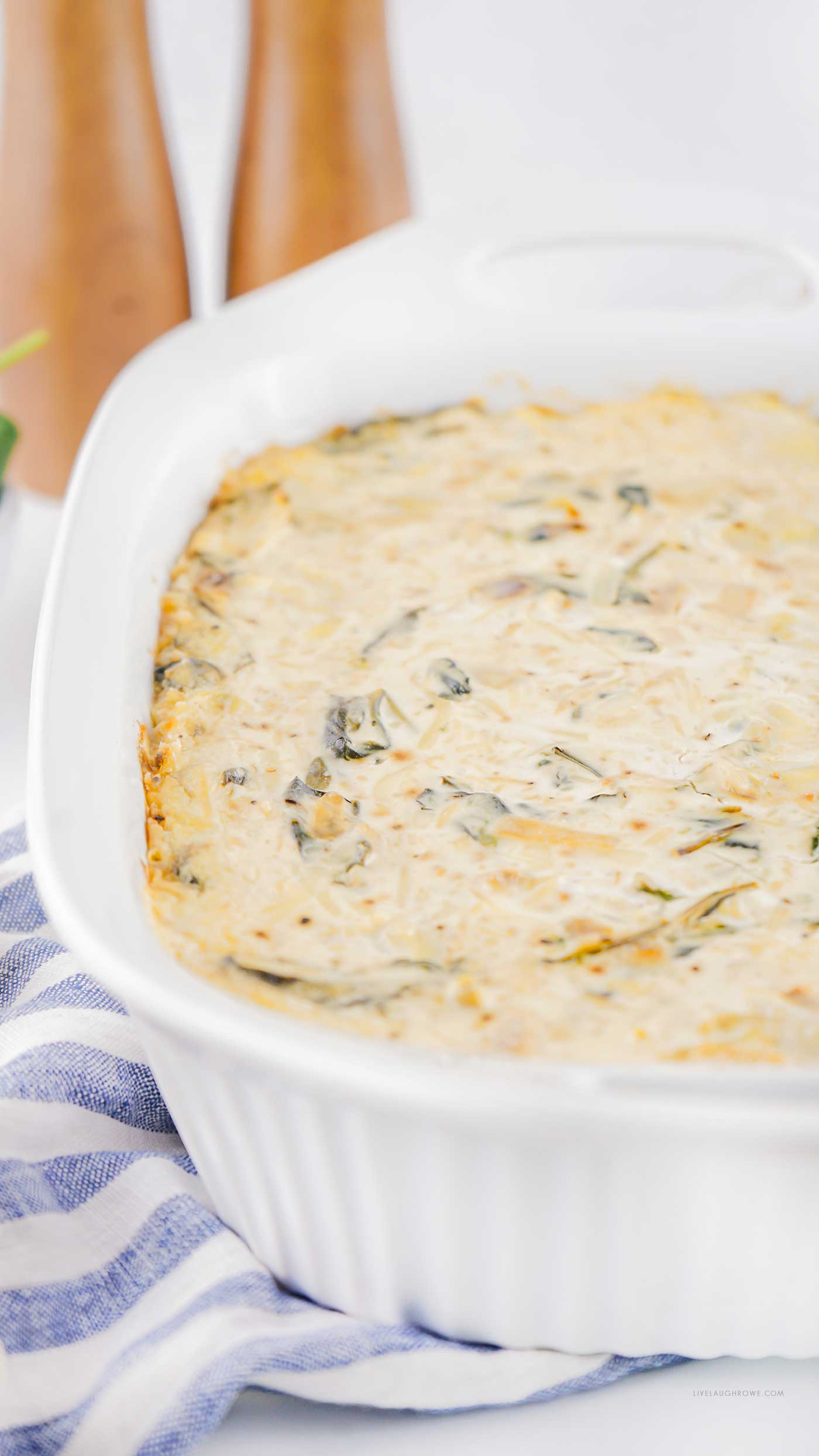 Baked dip in a white casserole dish, hot and bubbly, ready to serve.
