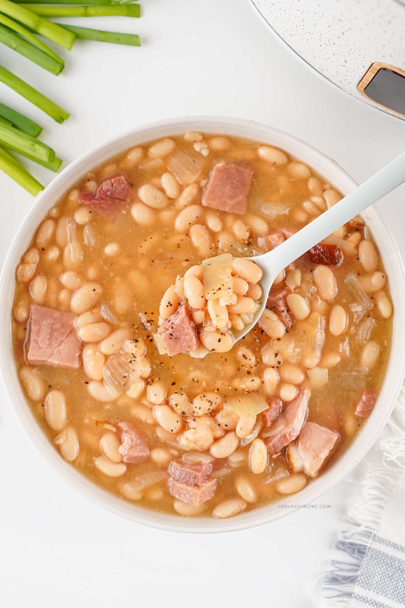 Bowl of homemade soup with tender white beans and cubed ham
