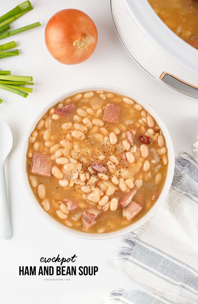 Ham and bean soup served in a white bowl with simple garnishes