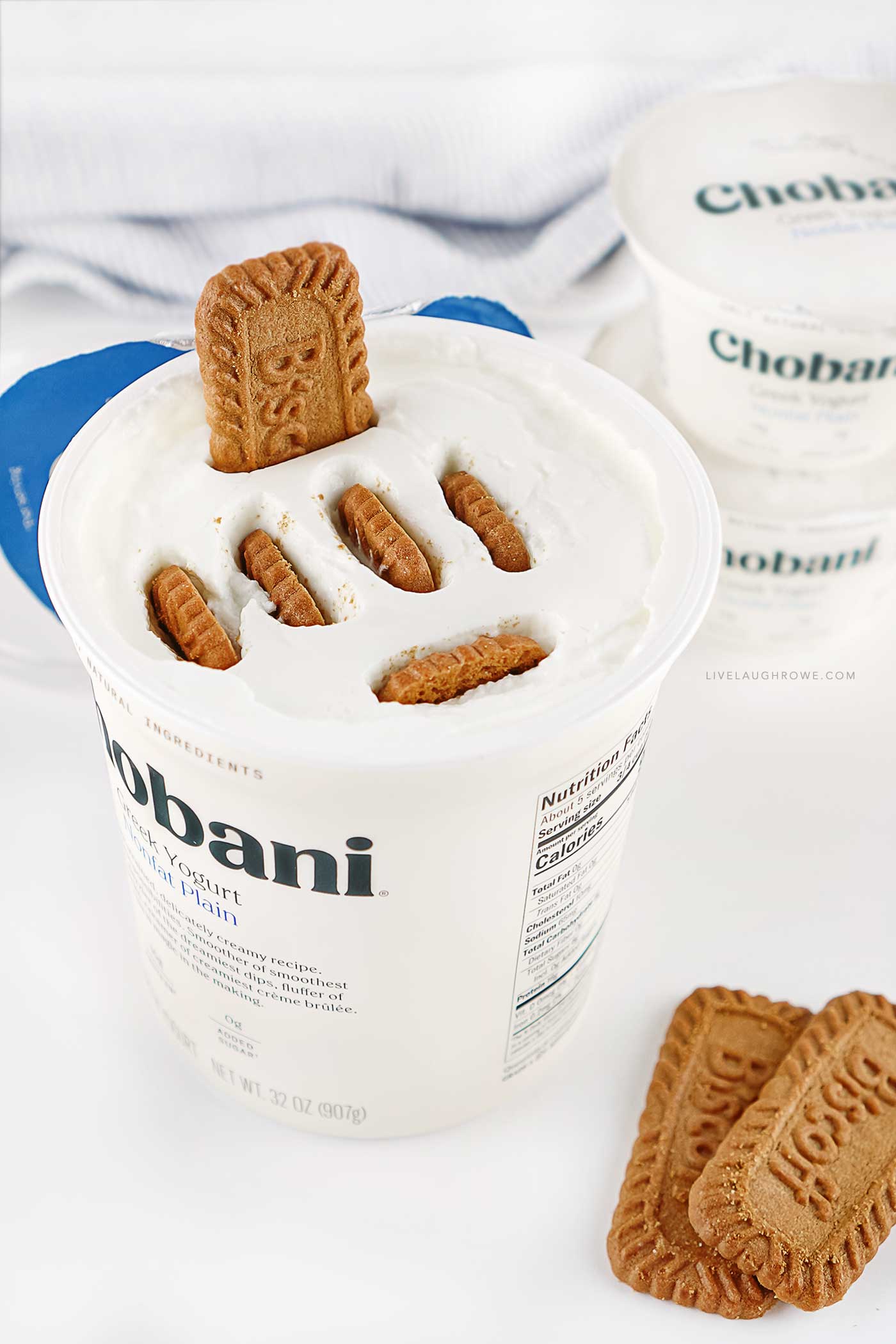 Large container of Greek yogurt layered with Biscoff cookies to create an easy no-bake Japanese cheesecake.