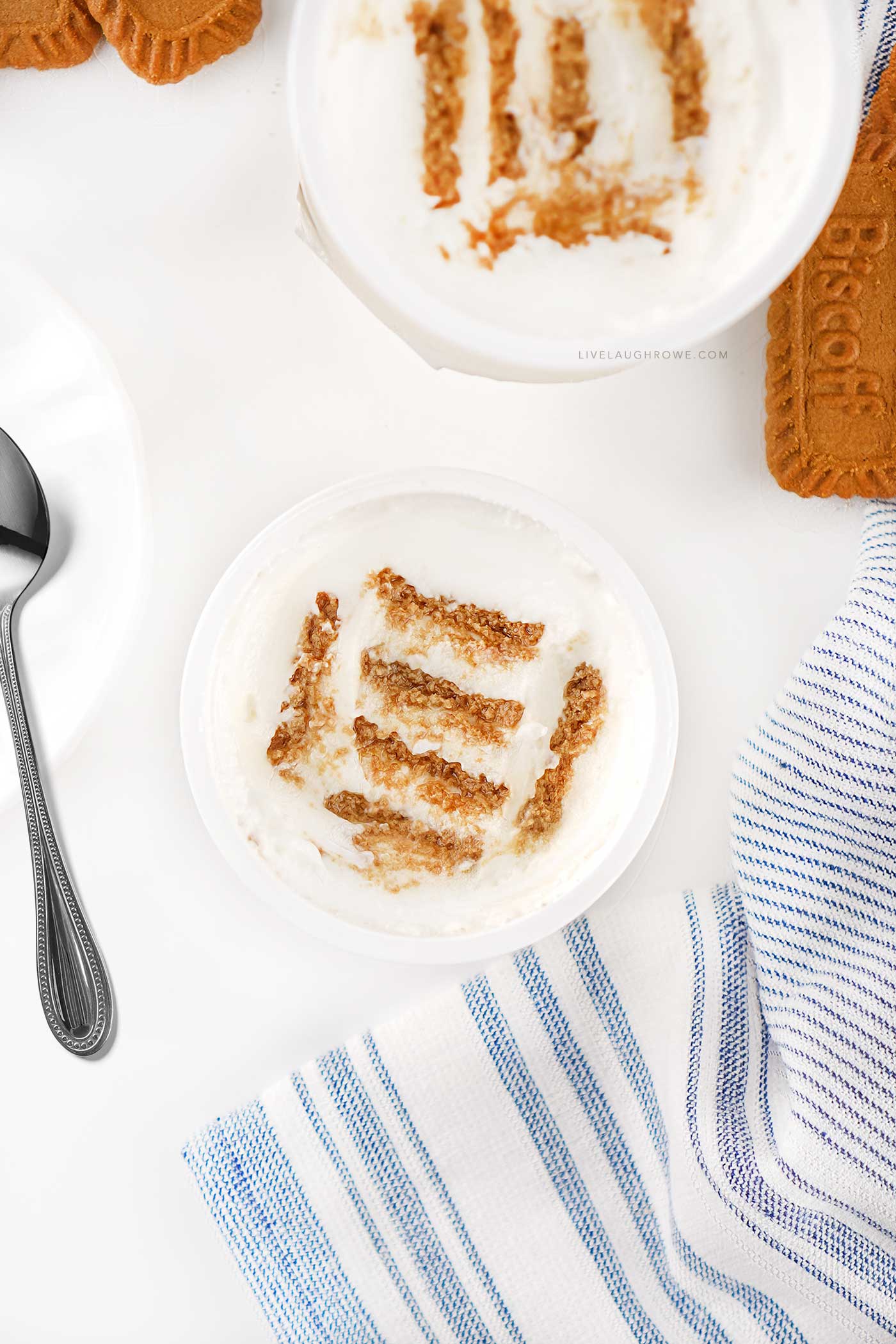 Overhead view of viral Japanese cheesecake made with Greek yogurt and softened Biscoff cookies layered inside a white bowl.