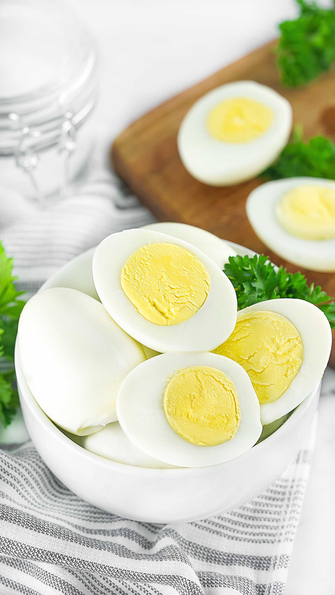 Peeled hard boiled eggs sliced in half and arranged in a glass bowl
