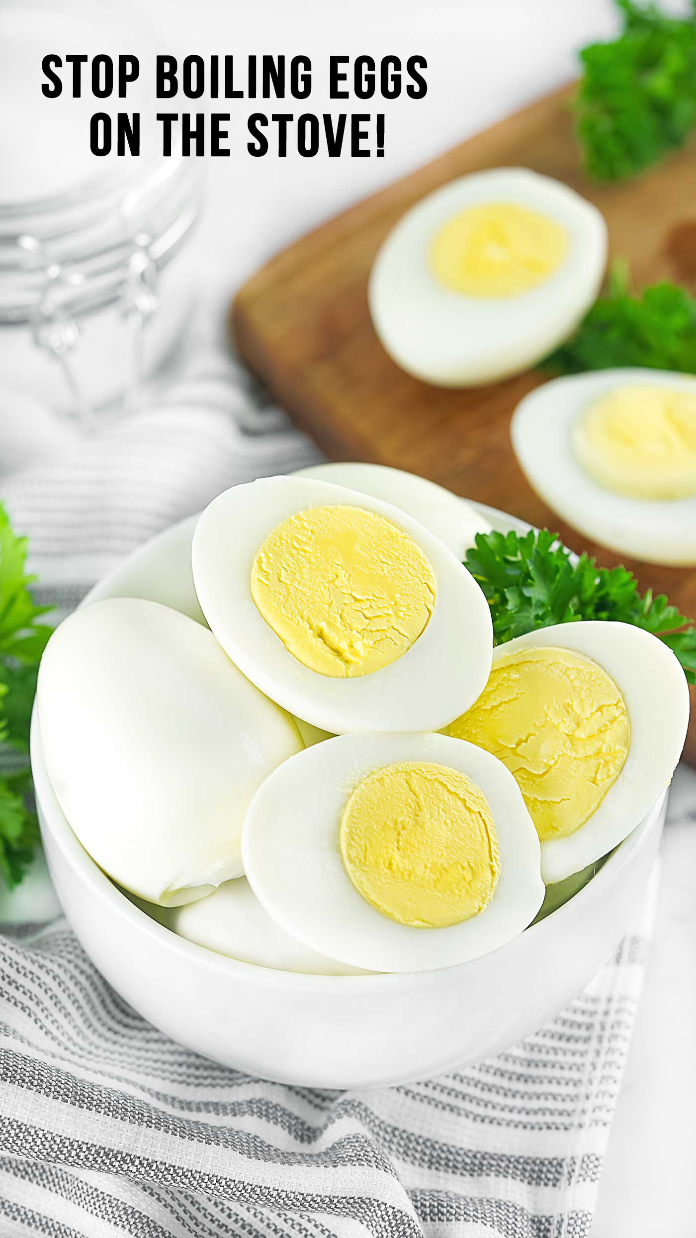 Peeled hard boiled eggs sliced in half and arranged in a glass bowl