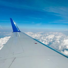 wing of a plane among the clouds