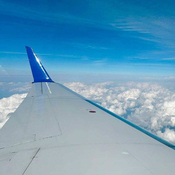 wing of a plane among the clouds