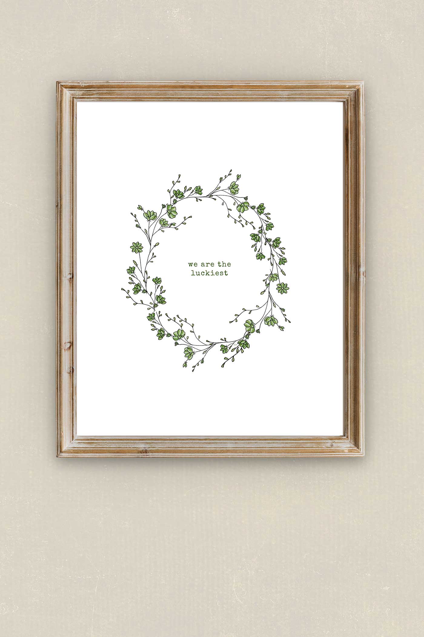 Minimalist botanical wreath wall art in a light wood frame