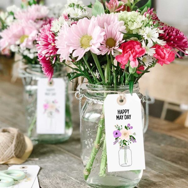 square image of mason jars filled with pink and white flowers with a Happy May Day printable tag attached