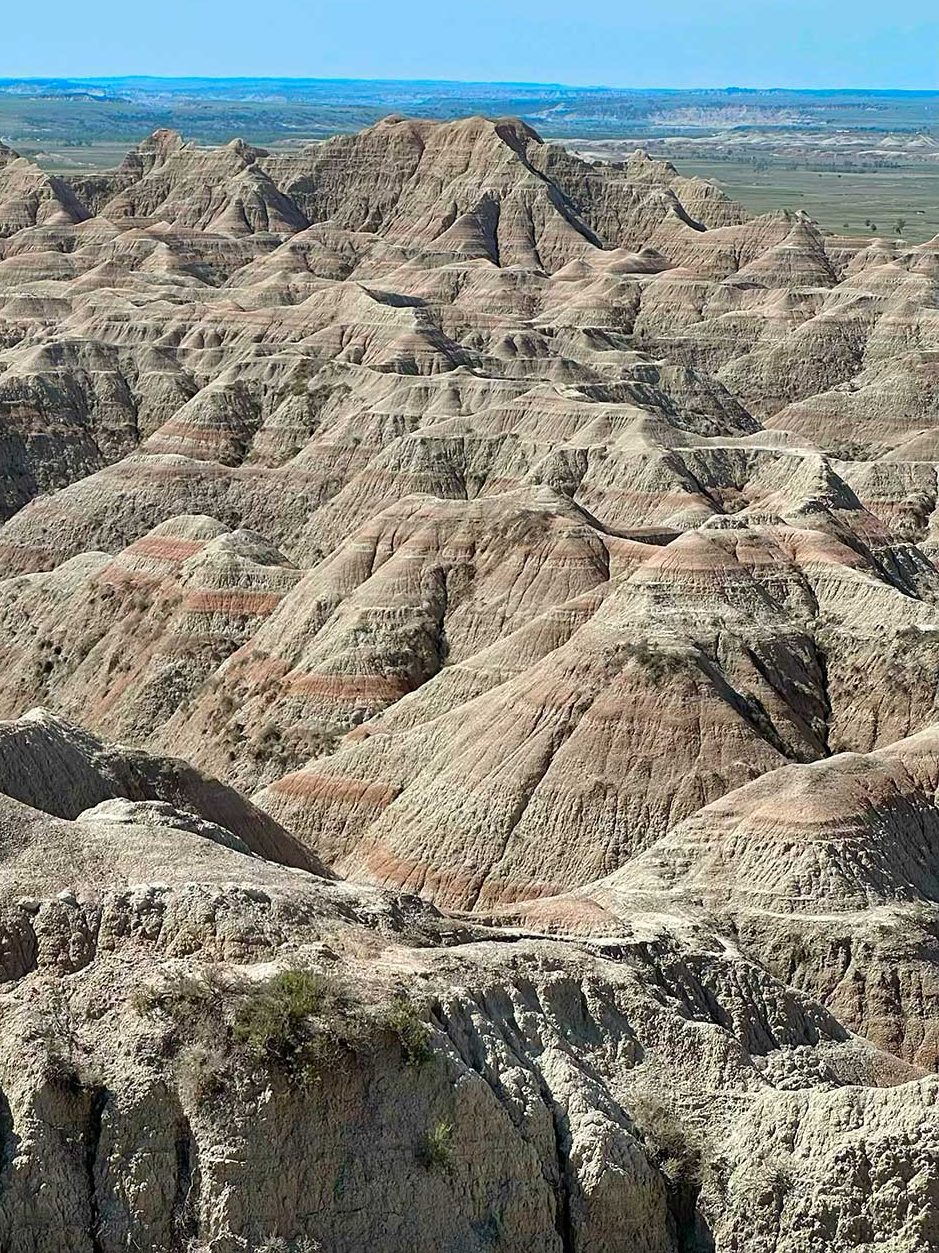Layered rock formations stretching across the landscape at Badlands National Park.